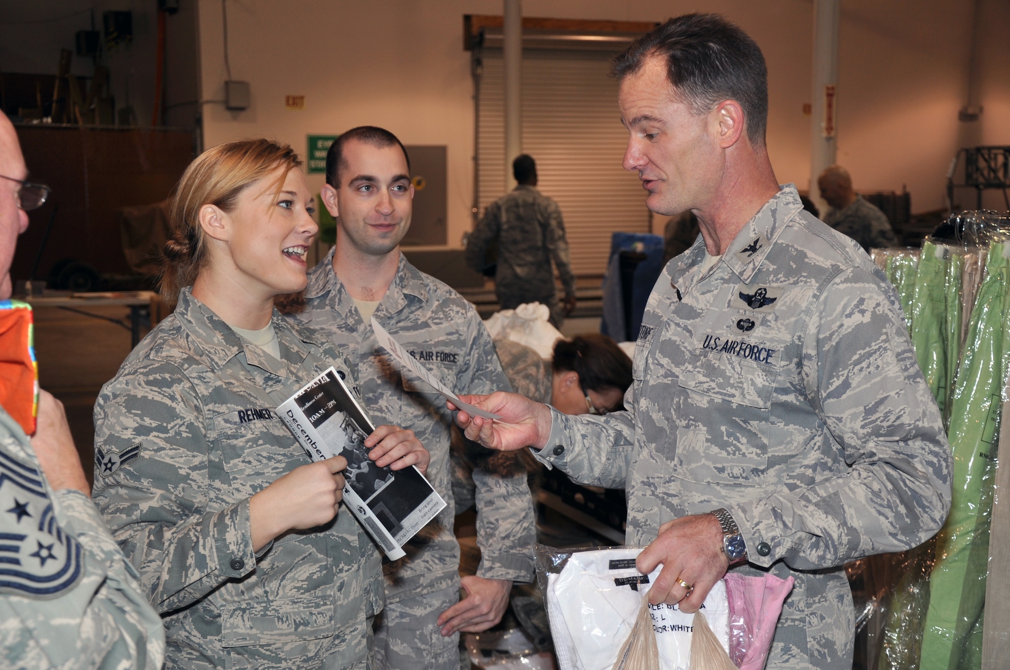 Col. Eric Overturf, 442nd Fighter Wing commander, talk to Airman 1st Class Jennifer Rehmer, 442nd Force Support Squadron, about the 442nd Christmas Store, Dec. 3, 2011. The Christmas Store offered free items to Airmen and dependents during the holiday season. The 442nd FW is an A-10 Thunderbolt II Air Force Reserve unit at Whiteman Air Force Base, Mo. (U.S. Air Force photo/Tech. Sgt. Kent Kagarise)
