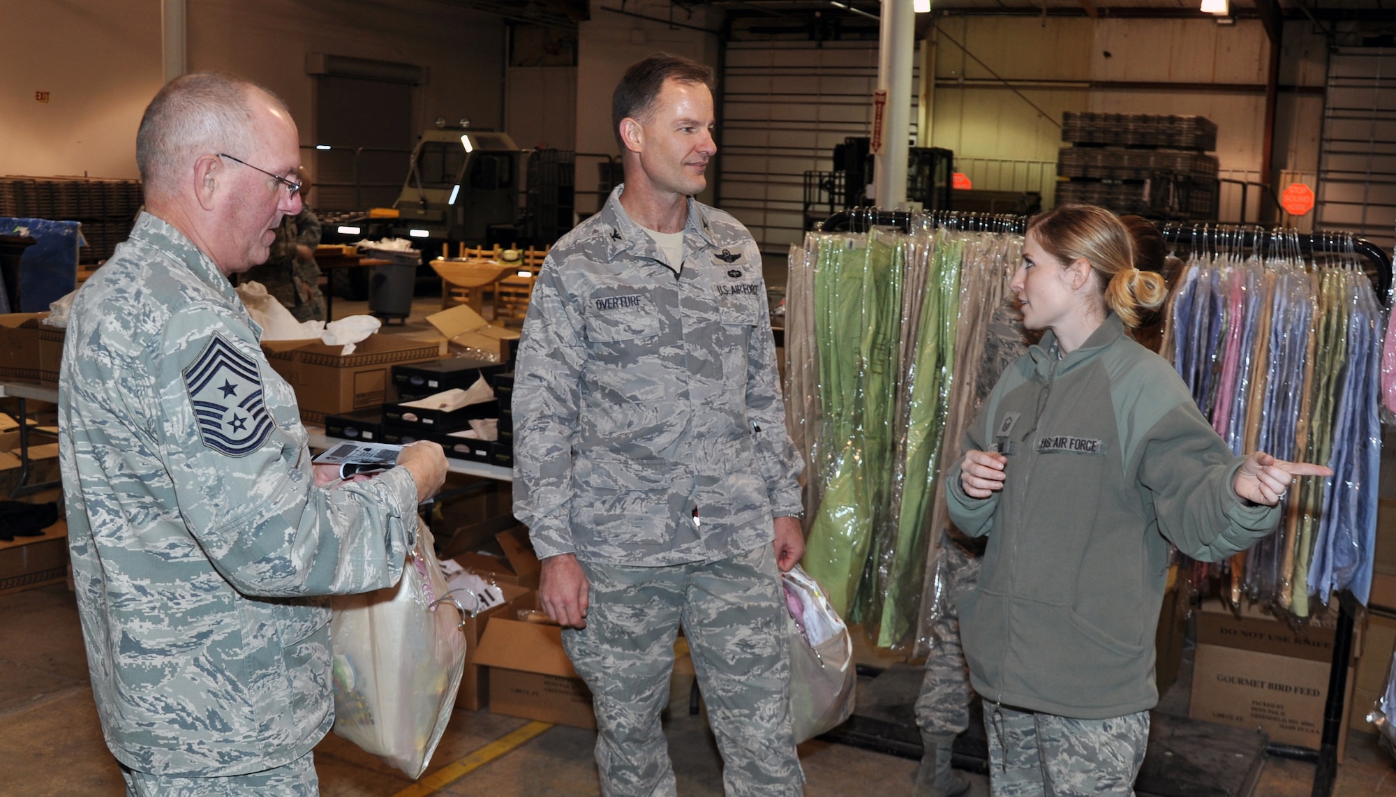 Command Chief Master Sgt. Allan Sturges and Col. Eric Overturf, 442nd Fighter Wing commander, talk to Master Sgt. Nikki Adams, noncommissioned officer in charge of Airman and Family Readiness, during the Christmas Store, Dec. 3, 2011. The Christmas Store offered free items to Airmen and dependents during the holiday season. The 442nd FW is an A-10 Thunderbolt II Air Force Reserve unit at Whiteman Air Force Base, Mo. (U.S. Air Force photo/Tech. Sgt. Kent Kagarise)