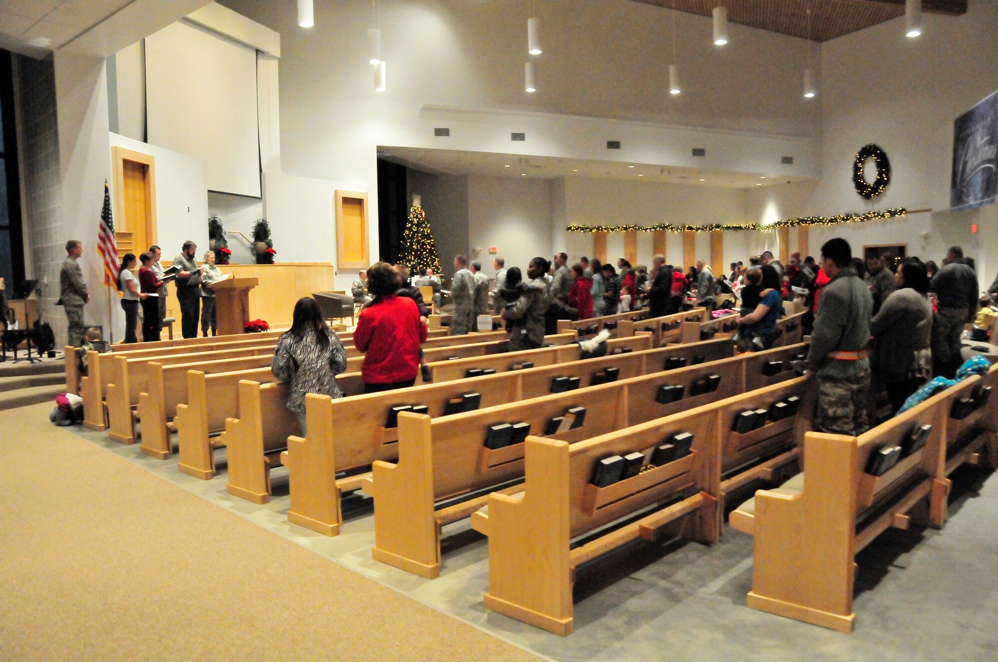Members of the Iceman team sing holiday carols at the base chapel during the 354th Fighter Wing base holiday tree lighting ceremony here Dec. 1.  The festivities were followed by the Family Holiday Celebration, sponsored by the 354th Force Support Squadron, which featured music, food and a visit by Santa Claus. (U.S. Air Force photo/Staff Sgt. Miguel Lara III)