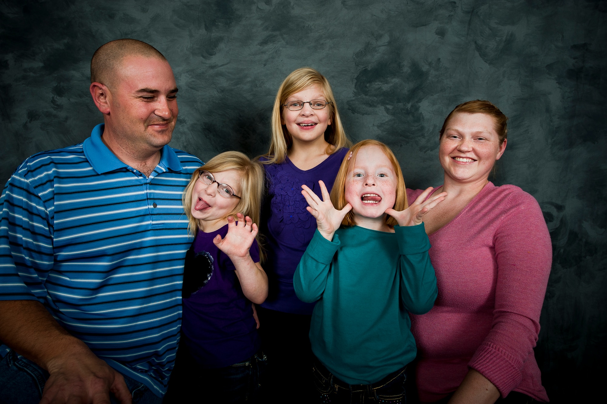 U.S. Air Force Tech. Sgt. Christopher and Staff Sgt. Denne Boykins and their children, Abigail, Bethany and Samantha, pose for a family photo at Moody Air Force Base, Ga., Nov. 30, 2011. In 2008, the Boykins gained custody of the three girls through an adoption program. Military members who are interested in adoption can find more information through Family Advocacy, the Airman and Family Readiness Center, http://www.militaryfamily.org/resources/links/adoption.html or http://www.childwelfare.gov/pubs/f_milita.cfm. (U.S. Air Force photo by Staff Sgt. Jamal D. Sutter/Released)