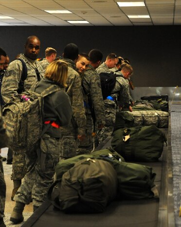 Airmen from Joint Base Charleston wait for their luggage at the Passenger Terminal Dec. 5 at Joint Base Charleston - Air Base, as the Operational Readiness Inspection comes to an end. The ORI lasted from Nov. 29 through Dec. 6. (U.S. Air Force photo/Airmen 1st Class Ashlee Galloway)