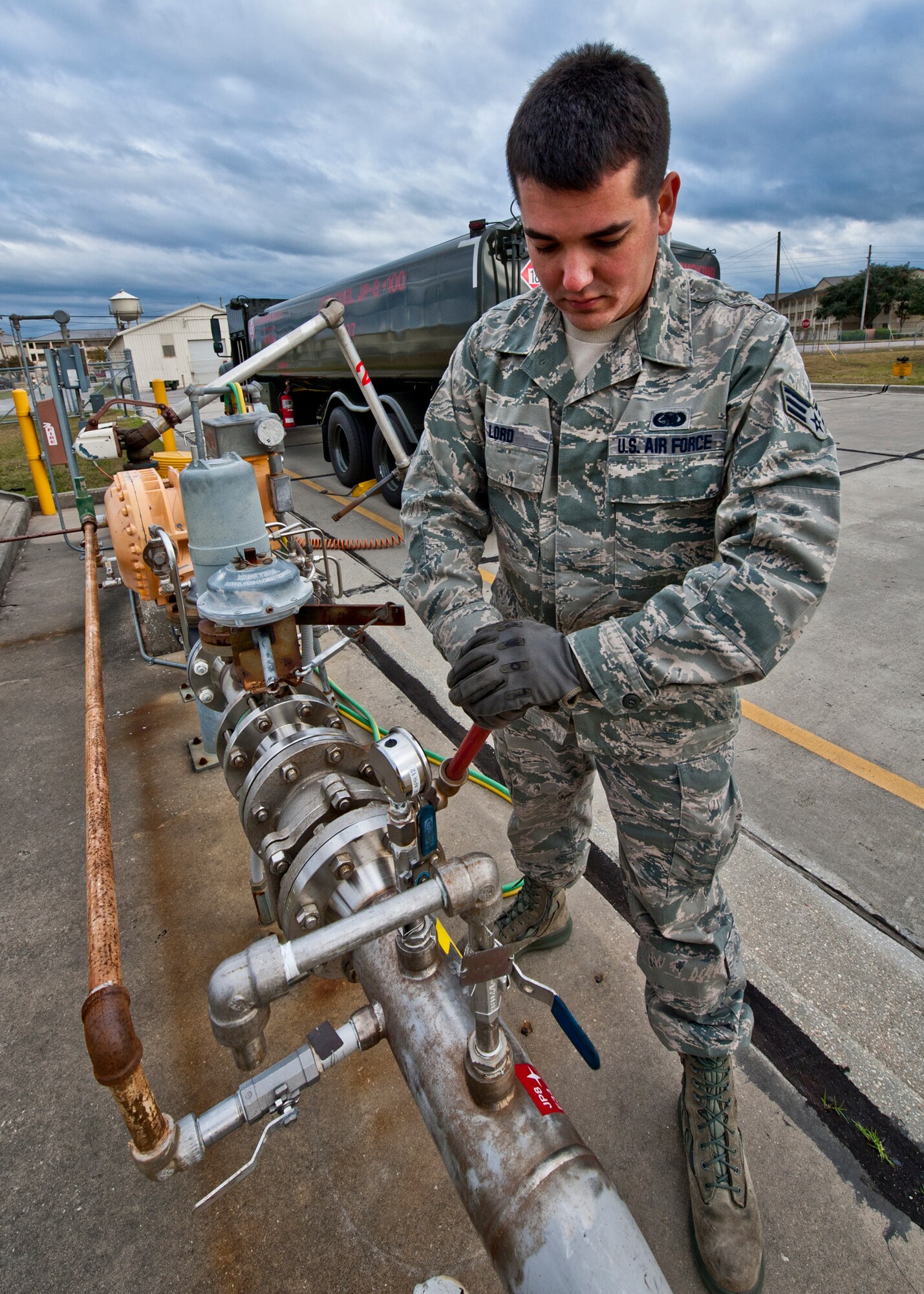 Senior Airman Jason Lord, of the 96th Logistics Readiness Squadron, opens the valve to release the JP-8 to fill up his 6,000 gallon R-11 tanker truck.  The fuel flows from a large storage tank into the truck.  It will remain in the vehicle until it is delivered to the aircraft. Last year, more than 14 million gallons of fuel and cryogenics products were delivered by the flight to fulfill the 8,000 test and training missions on base. (U.S. Air Force photo/Samuel King Jr.)