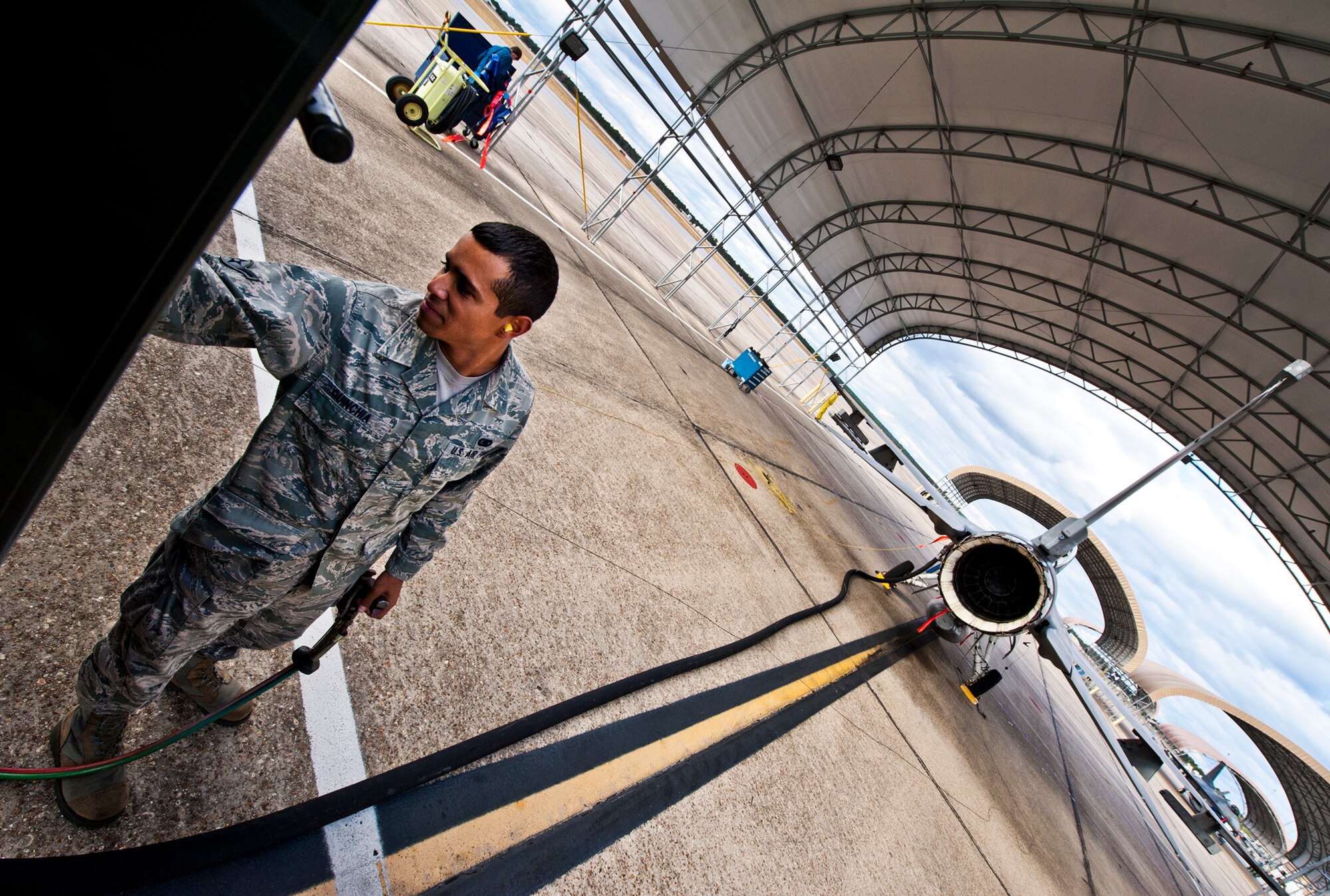 Airman Jonathan Quinchia, of the 96th Logistics Readiness Squadron, adjusts a dial while refueling a 46th Test Wing F-16 Fighting Falcon at Eglin Air Force Base, Fla.  When a call for a refuel or defuel comes in, the goal for a petroleum, oil and lubricants operator is to deliver it in 30 minutes or less.  Last year, more than 14 million gallons of fuel and cryogenics products were delivered by the flight to fulfill the 8,000 test and training missions on base. (U.S. Air Force photo/Samuel King Jr.)