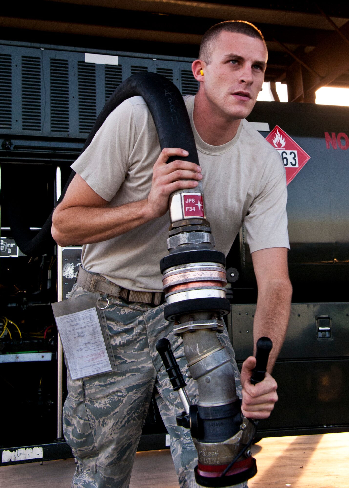 Senior Airman Adam Riggs, of the 96th Logistics Readiness Squadron, unwinds the fuel hose from an R-11 truck during its morning inspection at Eglin Air Force Base, Fla.  Each morning, Airmen from the petroleum, oil and lubricants flight inspect every fuel truck in the fleet to include checking the seals, lights, the hoses for tears or gashes and taking fuel samples from the bottom of each tank.  (U.S. Air Force photo/Samuel King Jr.)