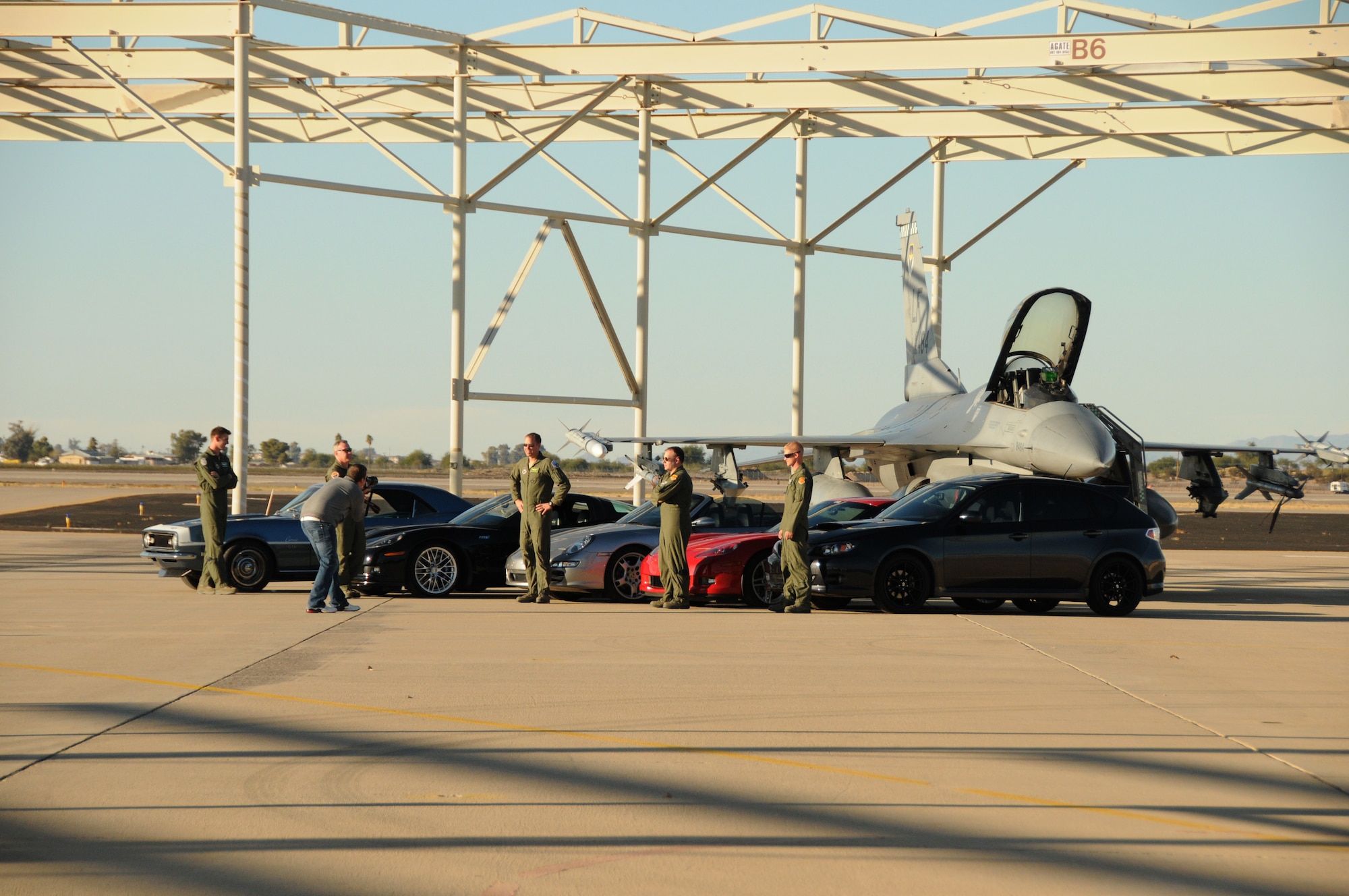 Highline Auto Magazine conducted a photo shoot on the 944th Fighter Wing flightline ramp yesterday.  Five car enthusiasts from the 56th Fighter Wing and the 944th Fighter Wing got the chance to show off their wheels during the shoot. The cars (and their owners) were posed in front of an F-16 and will appear in the January issue of the magazine. (U.S. Air Force photo/Capt. Elizabeth Magnusson)