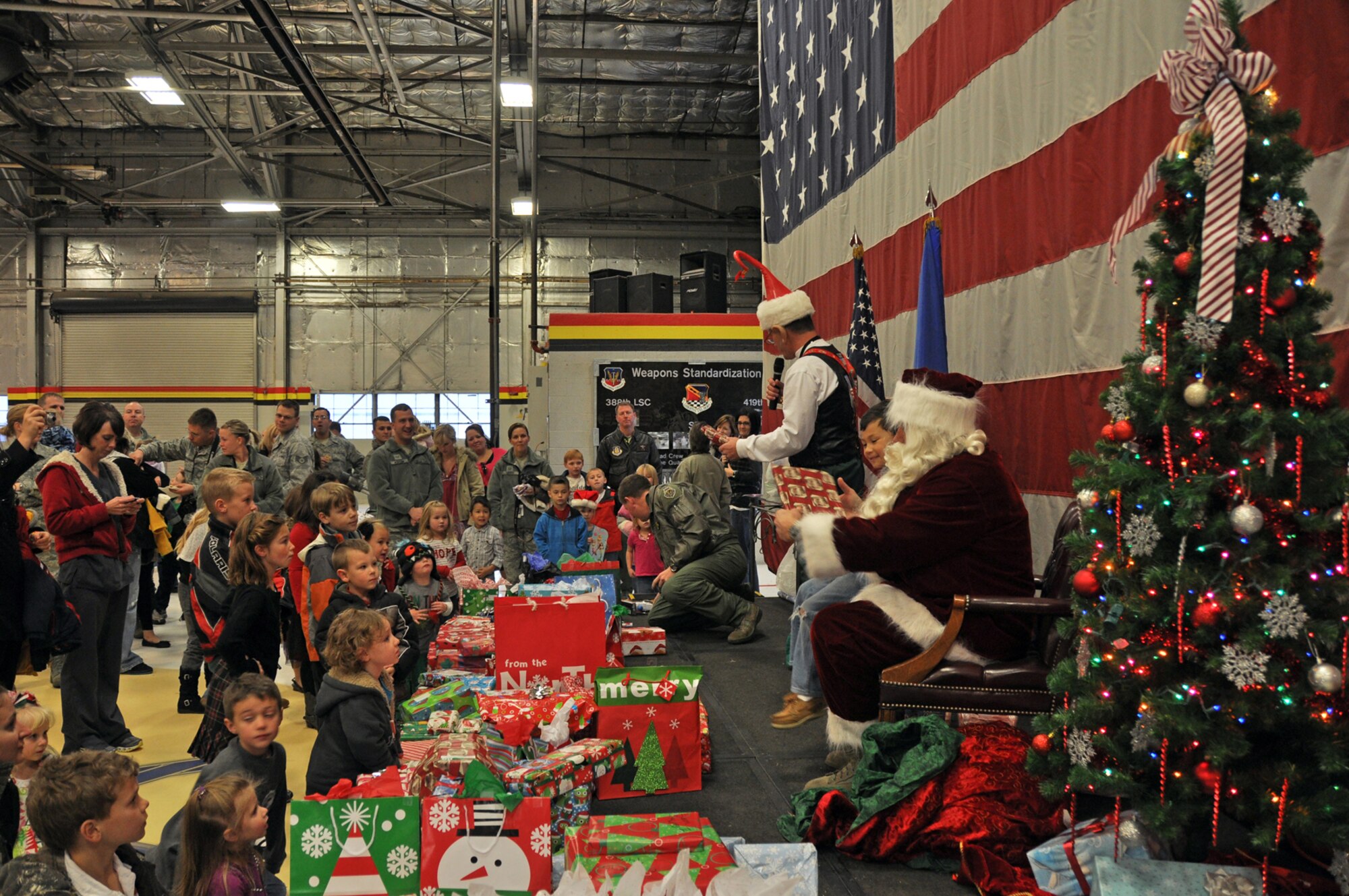 Children wait eagerly for Santa’s helper to call their name so they can meet Santa. More children came to see Santa this year than ever before. (U.S. Air Force photo/Airman 1st Class Crystal Charriere)