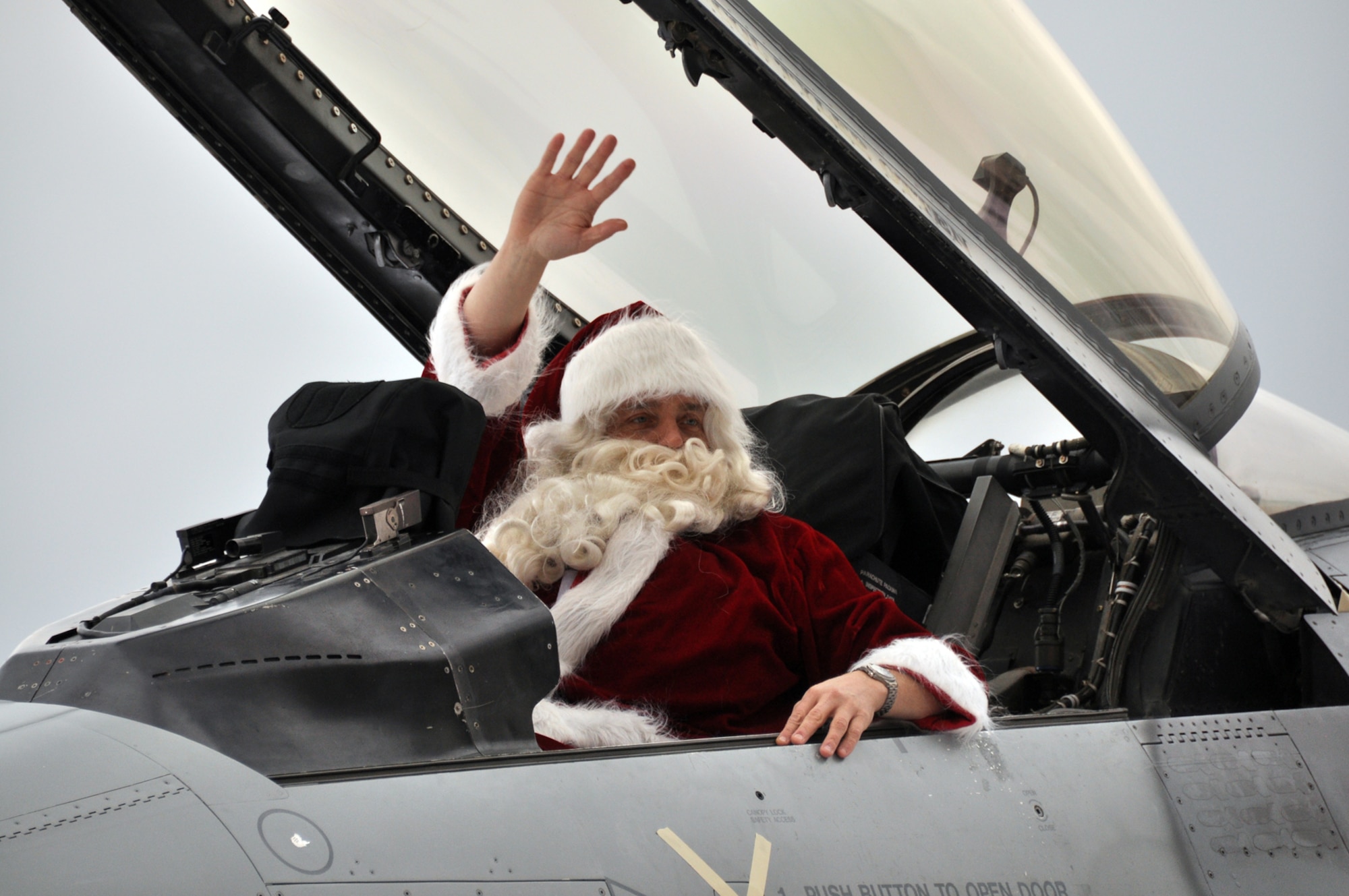 Santa, played by 419th Fighter Wing Commander Col. Keith Knudson, waves upon arriving at the wing’s Christmas party Sunday. About 100 children waited outside Hangar 37 as Santa made his grand entrance via F-16. (U.S. Air Force photo/Airman 1st Class Crystal Charriere)