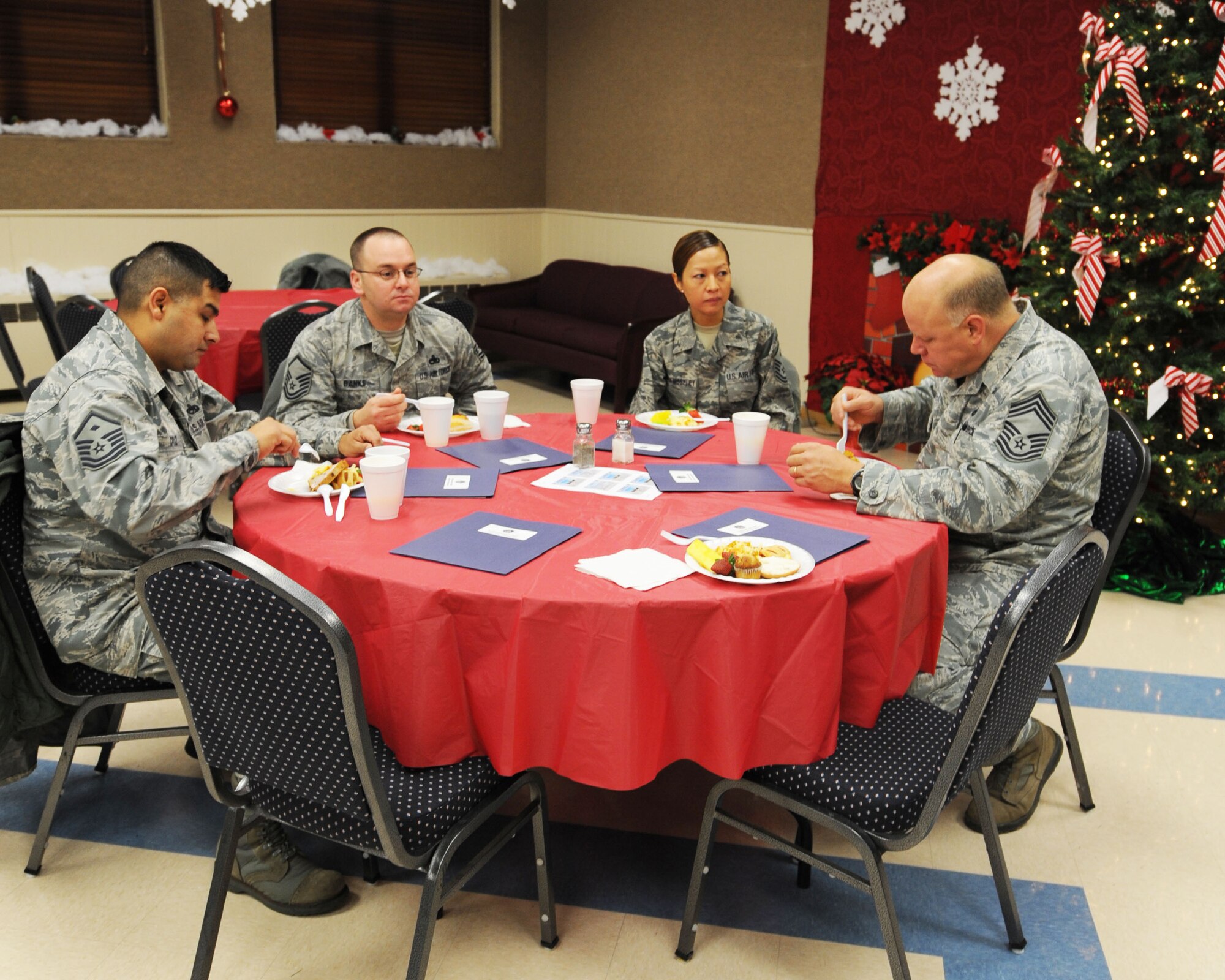 Dyess chiefs and first sergeants enjoy a breakfast prepared by the chapel staff Dec. 6, 2011, at Dyess Air Force Base, Texas. The chapel seeks to provide excellent spiritual help and encouragement for all military members and their families and to give counseling, advice or prayer. (U.S. Air Force photo by Airman 1st Class Cierra Bullock/Released)