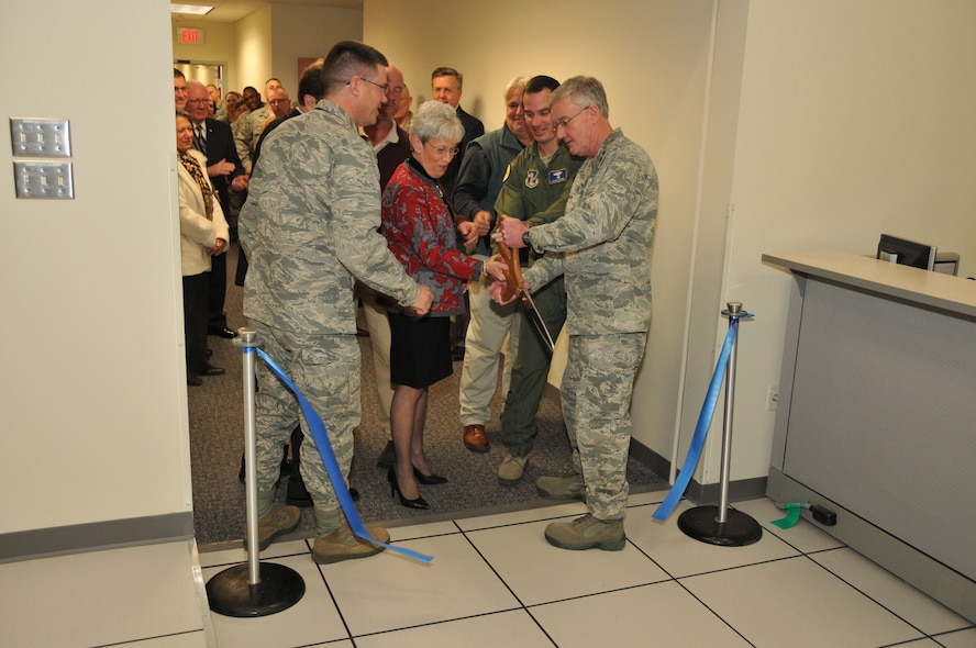 Col. Peter DePatie, 103rd Air Operations commander, watches as Connecticut Lieutenant Governor Nancy Wyman, 103rd Airlift Wing commander Col. Frank Detorie and Maj. Gen. Thaddeus Martin, The Adjutant General and commander of the Connecticut National Guard, cut the ribbon to the 103rd Air Operations Group’s new facility at Bradley Air National Guard Base, East Granby, Conn., Dec. 3, 2011. (U.S. Air Force photo by Airman 1st Class Emmanuel Santiago)