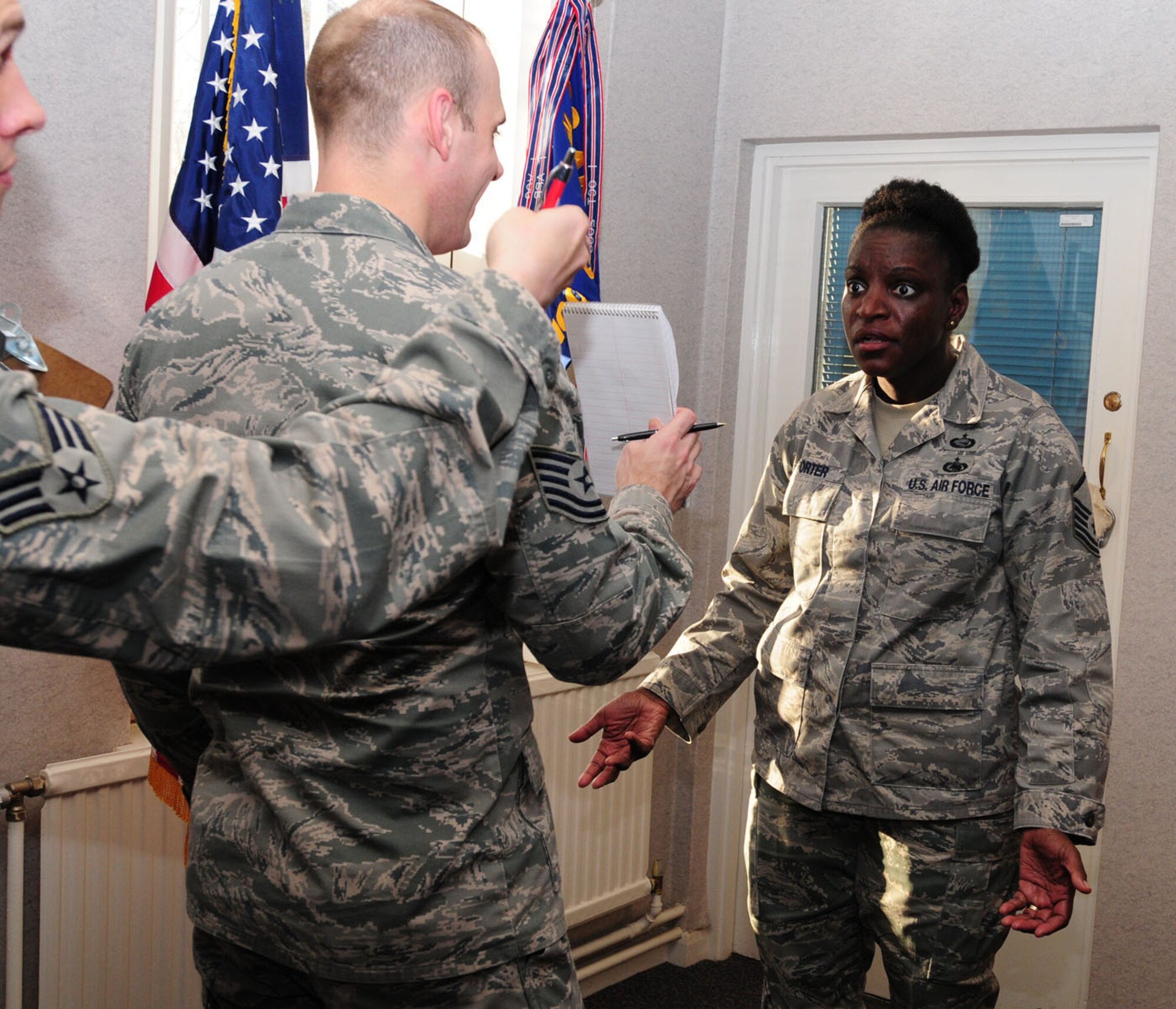 RAF MILDENHALL, England – Master Sgt. Eunice Porter, right, 100th Air Refueling Wing Equal Opportunity office, looks in disbelief at a sketch as she attempts to guess what it is. Members from the 100th Comptroller Squadron formed two teams and played several games, including their own version of Pictionary, in an effort to promote team building here Dec. 2, 2011, as part of Wingman Day. (U.S. Air Force photo/Karen Abeyasekere) 