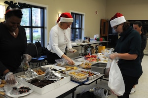 Members from Team Charleston Spouses Club sort and package cookies during their Annual Cookie Drop Dec. 6 at the Joint Base Charleston-Air Base Chapel Annex.  The cookie drop collected homemade cookies that were donated to Airmen and Sailors living in the dorms and to those who are deployed. (U.S. Air Force photo/Airman 1st Class Ashlee Galloway)