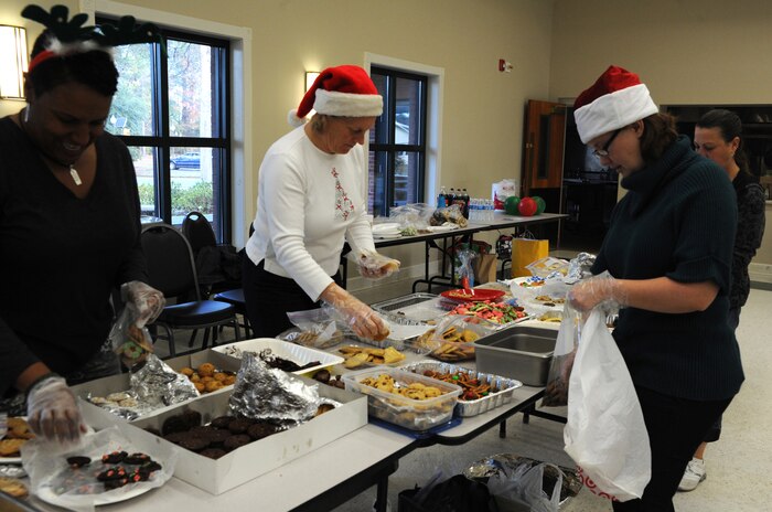 Members from Team Charleston Spouses Club sort and package cookies during their Annual Cookie Drop Dec. 6 at the Joint Base Charleston-Air Base Chapel Annex.  The cookie drop collected homemade cookies that were donated to Airmen and Sailors living in the dorms and to those who are deployed. (U.S. Air Force photo/Airman 1st Class Ashlee Galloway)
