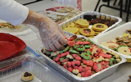 Mary Beth Davey, Team Charleston Spouses Club member, packages cookies during the annual cookie drop Dec. 6, 2011, at  Joint Base Charleston, S.C. The cookie drop collected homemade cookies that were donated to Airmen and Sailors living in the dorms and to those who are deployed. (U.S. Air Force photo/Airman 1st Class Ashlee Galloway)