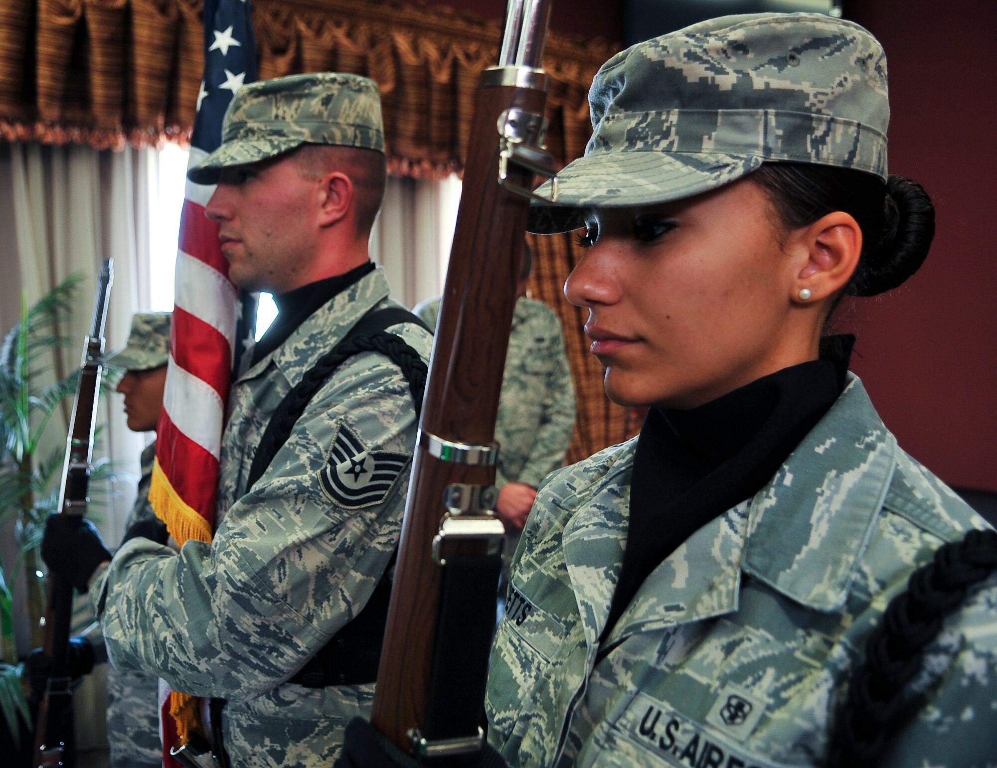 Senior Airman Amber Metts, 379th Expeditionary Medical Group Bioenvironmental Engineering technician, holds a rifle during an honor guard detail at a Pearl Harbor Remembrance Luncheon Dec. 7, 2011, at an undisclosed location in Southwest Asia. Metts, a native of St. Louis, Mo., is deployed from Holloman Air Force Base, N.M. (U.S. Air Force photo/Senior Airman Paul Labbe)