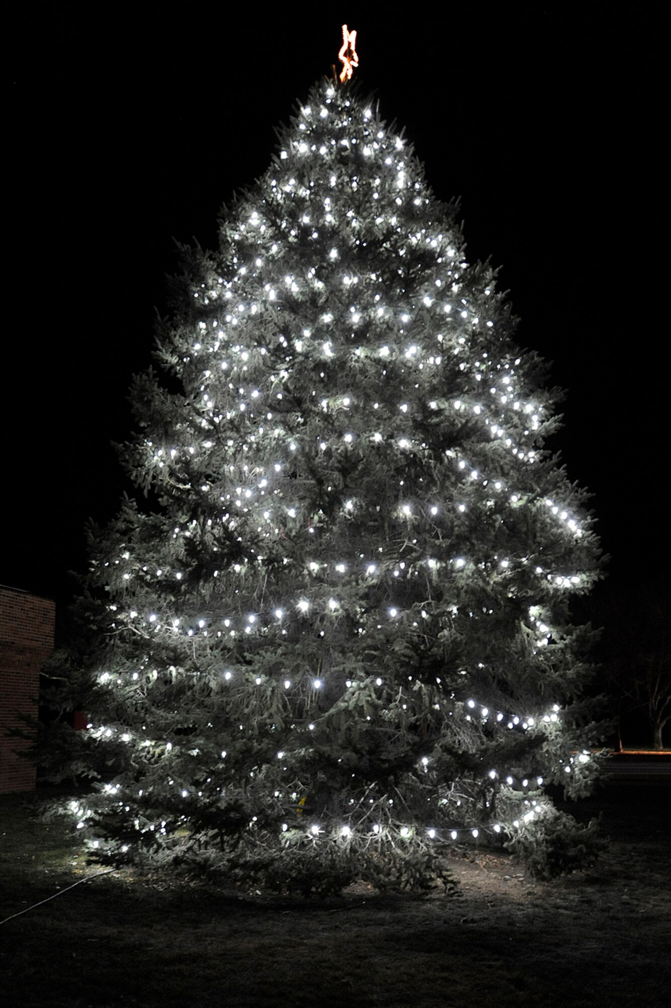 PETERSON AIR FORCE BASE, Colo. - Santa made an early visit to the base chapel Dec. 2 for the base tree lighting, where he visited with the families and spread holiday cheer. Despite the cold, about 100 people attended the tree lighting, which was followed by the monthly deployed families dinner. (U.S. Air Force photo/Rob Bussard)