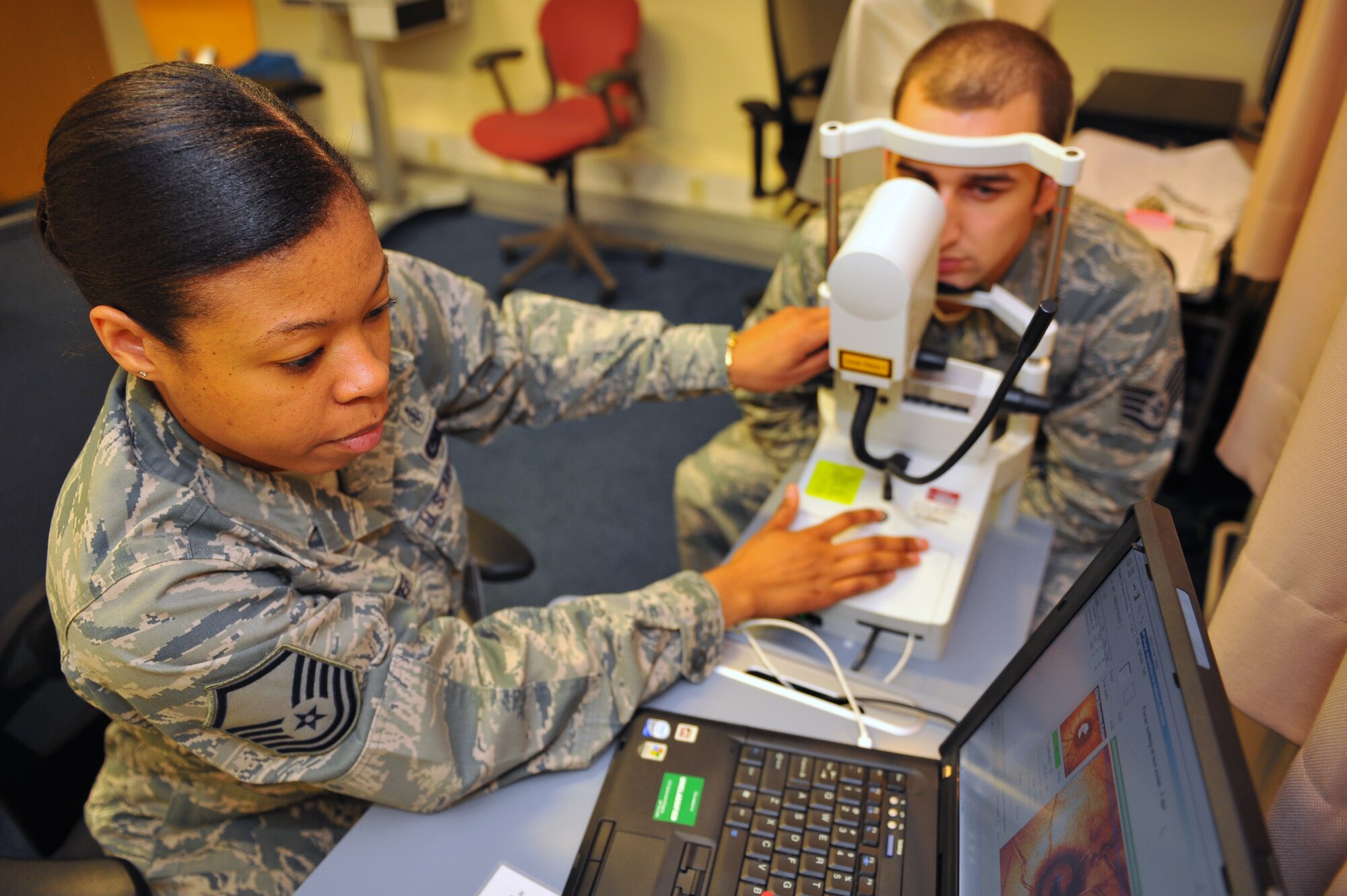 SPANGDAHLEM AIR BASE, Germany – Master Sgt. Candace Slaughter, 52nd Aerospace Medicine Squadron ophthalmic technician, uses a Heidelberg Retina Tomograph to digitally image the optical nerve of Staff Sgt. Nicholas Hubbard, 52nd AMDS ophthalmic technician, during a follow-up eye exam inside the optometry clinic here De. 6. The AMDS provides vision correction as well as diagnosing, treating and managing ocular diseases to keep Airmen fit to fight and their family members healthy. (U.S. Air Force photo/Airman 1st Class Dillon Davis)