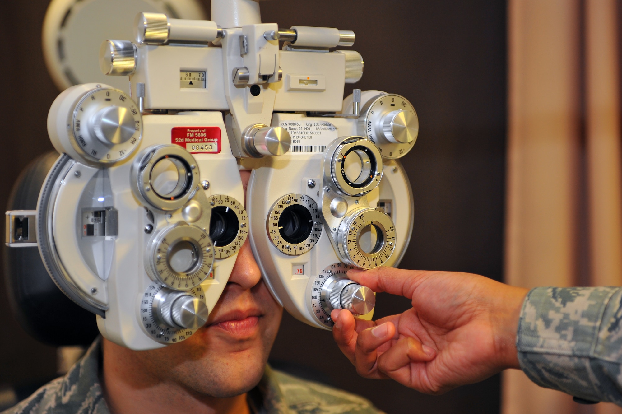 SPANGDAHLEM AIR BASE, Germany – Master Sgt. Candace Slaughter, 52nd Aerospace Medicine Squadron ophthalmic technician, uses a pheropter to determine a patient’s correct prescription during an eye exam at the optometry clinic here Dec. 6. The AMDS provides vision correction as well as diagnosing, treating and managing ocular diseases to keep Airmen fit to fight and their family members healthy. (U.S. Air Force photo/Airman 1st Class Dillon Davis)