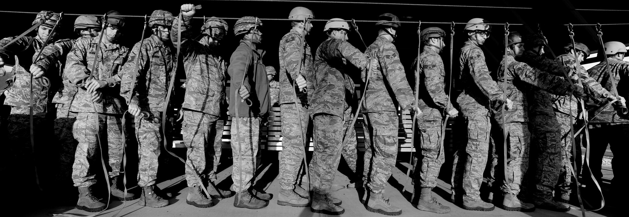 Airmen with the 8th Air Support Operations Squadron wait in line to practice jumps Dec. 6 at Aviano Air Base, Italy.  Military paratroopers are required to perform four practice falls before conducting static line jumps from any aircraft. (U.S. Air Force photo/Staff Sgt. Evelyn Chavez)