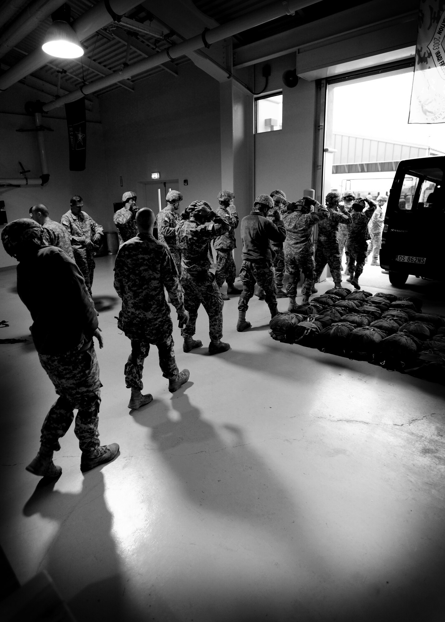 Airmen with the 8th Air Support Operations Squadron prepare to practice jumps Dec. 6 at Aviano Air Base, Italy.  Military paratroopers are required to participate in training before doing static line jumps from any aircraft. (U.S. Air Force photo/Staff Sgt. Evelyn Chavez)