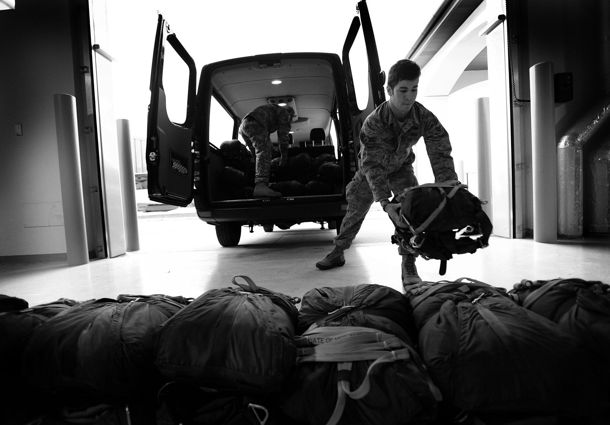 Airman 1st Class Jonathan Sepanik, 8th Air Support Operations Squadron tactical air control party operator, unloads parachutes Dec. 6 at Aviano Air Base, Italy. The 8th ASOS participated with the 173rd Airborne Combat Brigade Team during an airborne operation training. (U.S. Air Force photo/Staff Sgt. Evelyn Chavez)