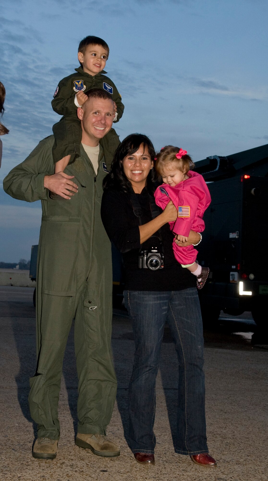 Maj. Chris Occhiuzzo, 20th Bomb Squadron, poses with his wife Olivia, and children Miles, 2, and Courtney, 11 months, on Barksdale Air Force Base, La., Dec. 2 upon his return from a deployment to Guam. The 20 BS deployed in support of the continuous bomber presence in the Pacific region. (U.S. Air Force photo/Airman 1st Class Benjamin Gonsier)(RELEASED)