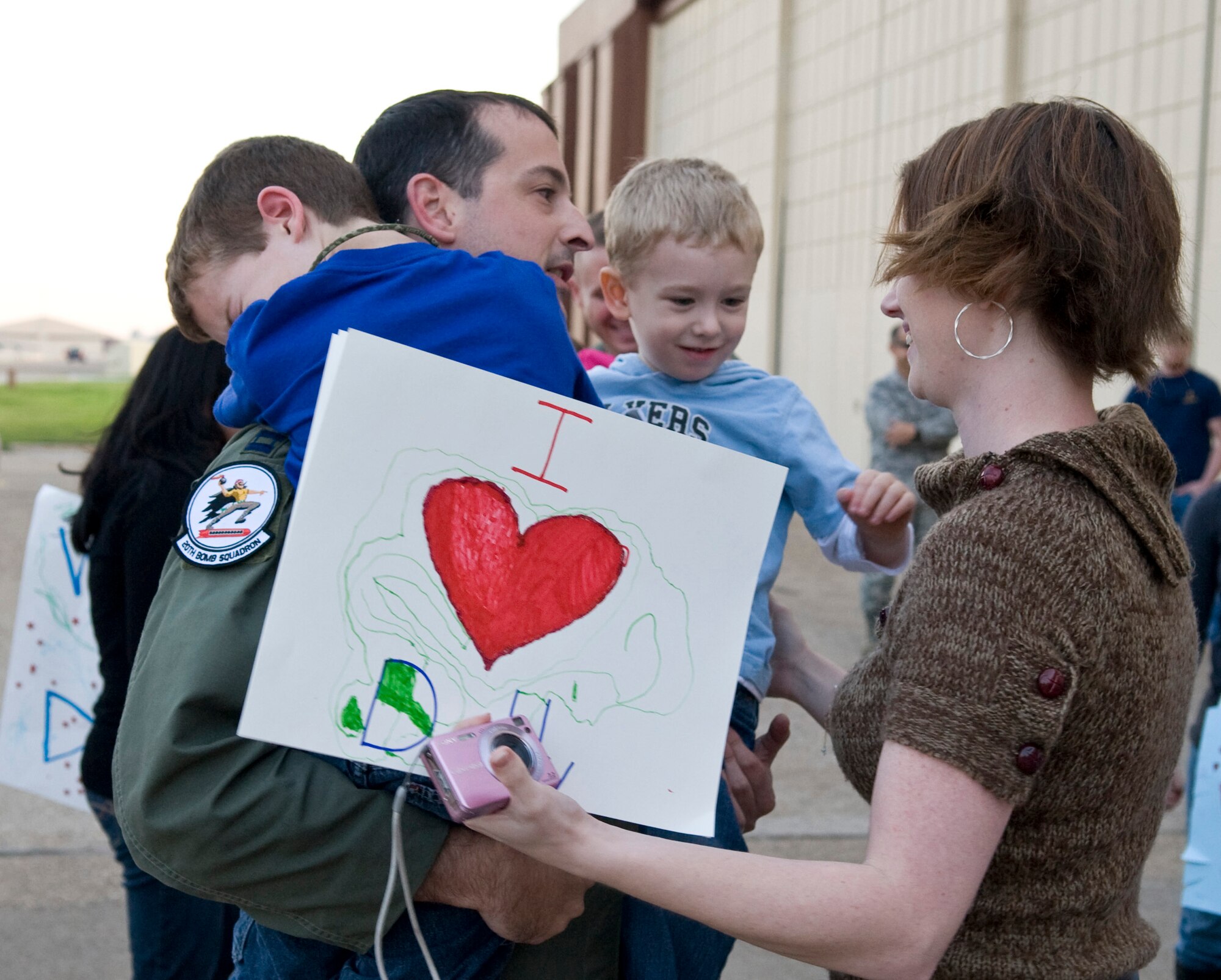 After a four-month deployment to Guam, Capt. Kyle Copus, 20th Bomb Squadron, greets his wife and children on Barksdale Air Force Base, La., Dec. 2. Members of the 20 BS were deployed to Guam in support of the continuous bomber presence in the Pacific region. (U.S. Air Force photo/Airman 1st Class Benjamin Gonsier)(RELEASED)