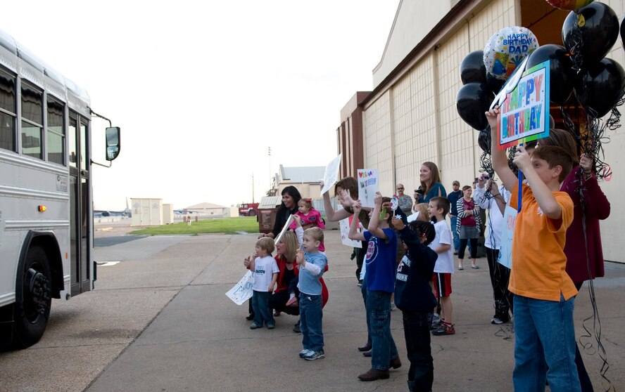 Families cheer as members of the 20th Bomb Squadron return from their deployment to Guam on Barksdale Air Force Base, La., Dec. 2. Dozens of base family members and friends were on scene to greet the returning Airmen. (U.S. Air Force photo/Airman 1st Class Benjamin Gonsier)(RELEASED)