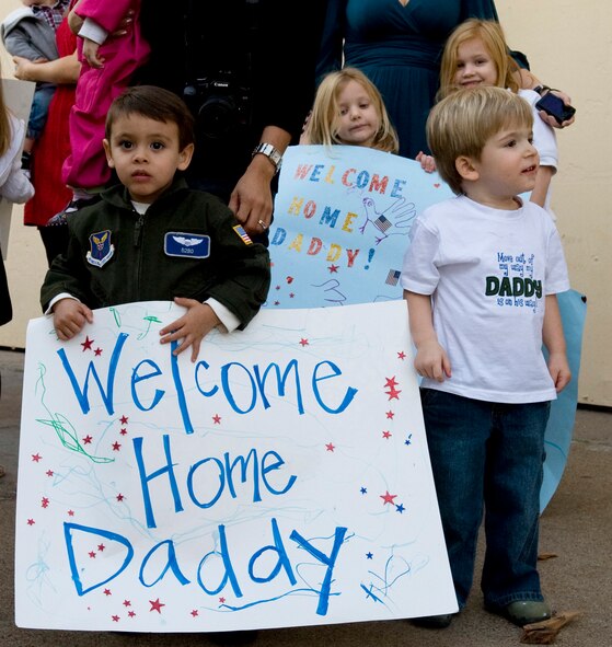 Families wait for loved ones to return from their deployment to Guam on Barksdale Air Force Base, La., Dec. 2. Members of the 20th Bomb Squadron were deployed in support of the continuous bomber presence in the Pacific region. (U.S. Air Force photo/Airman 1st Class Benjamin Gonsier)(RELEASED)