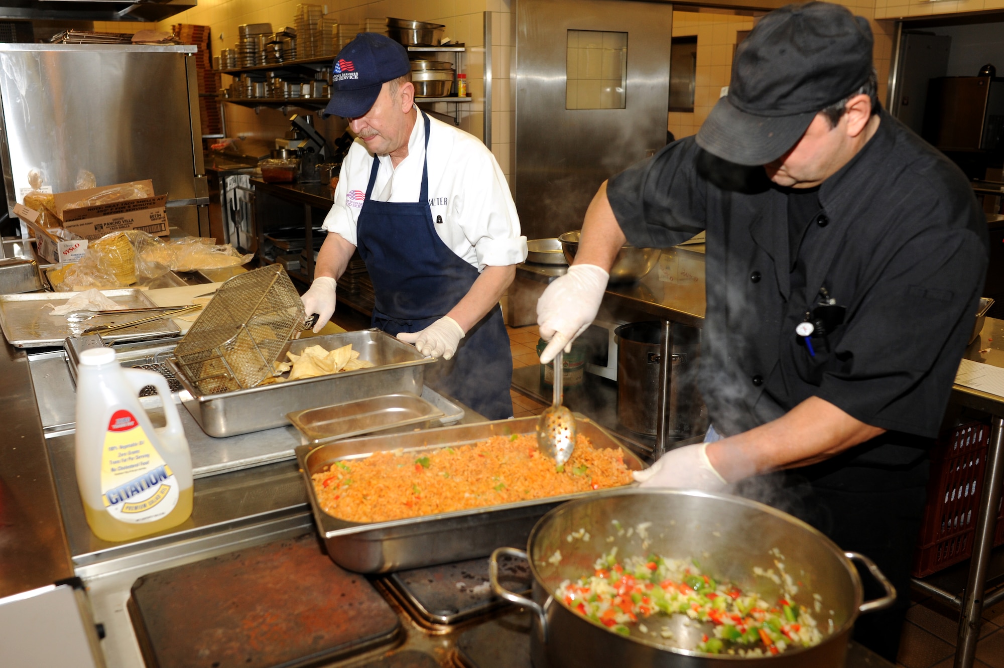 SPANGDAHLEM AIR BASE, Germany – Walter Vrzal, left, and Heinz Toeller, 52nd Force Support Squadron cooks, prepare lunch at Club Eifel here Dec. 1. Club Eifel Catering offers buffets and hors d’oeuvres style meals for pick-up or delivery and a catering staff upon request. For more information, call DSN 452-4642 or 06565-61-4642. (U.S. Air Force photo/Airman 1st Class Matthew B. Fredericks)