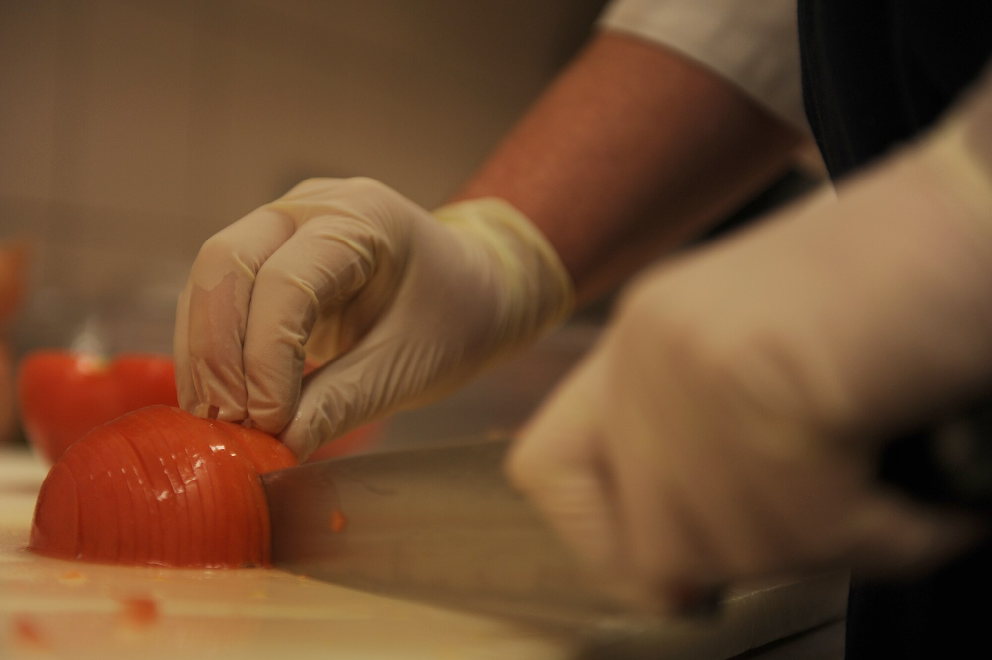 SPANGDAHLEM AIR BASE, Germany – Dennis Tautges, 52nd Force Support Squadron cook, dices a tomato for lunch at Club Eifel here Dec. 1. Club Eifel Catering offers buffets and hors d’oeuvres style meals for pick-up or delivery and a catering staff upon request. For more information, call DSN 452-4642 or 06565-61-4642. (U.S. Air Force photo/Airman 1st Class Matthew B. Fredericks)
