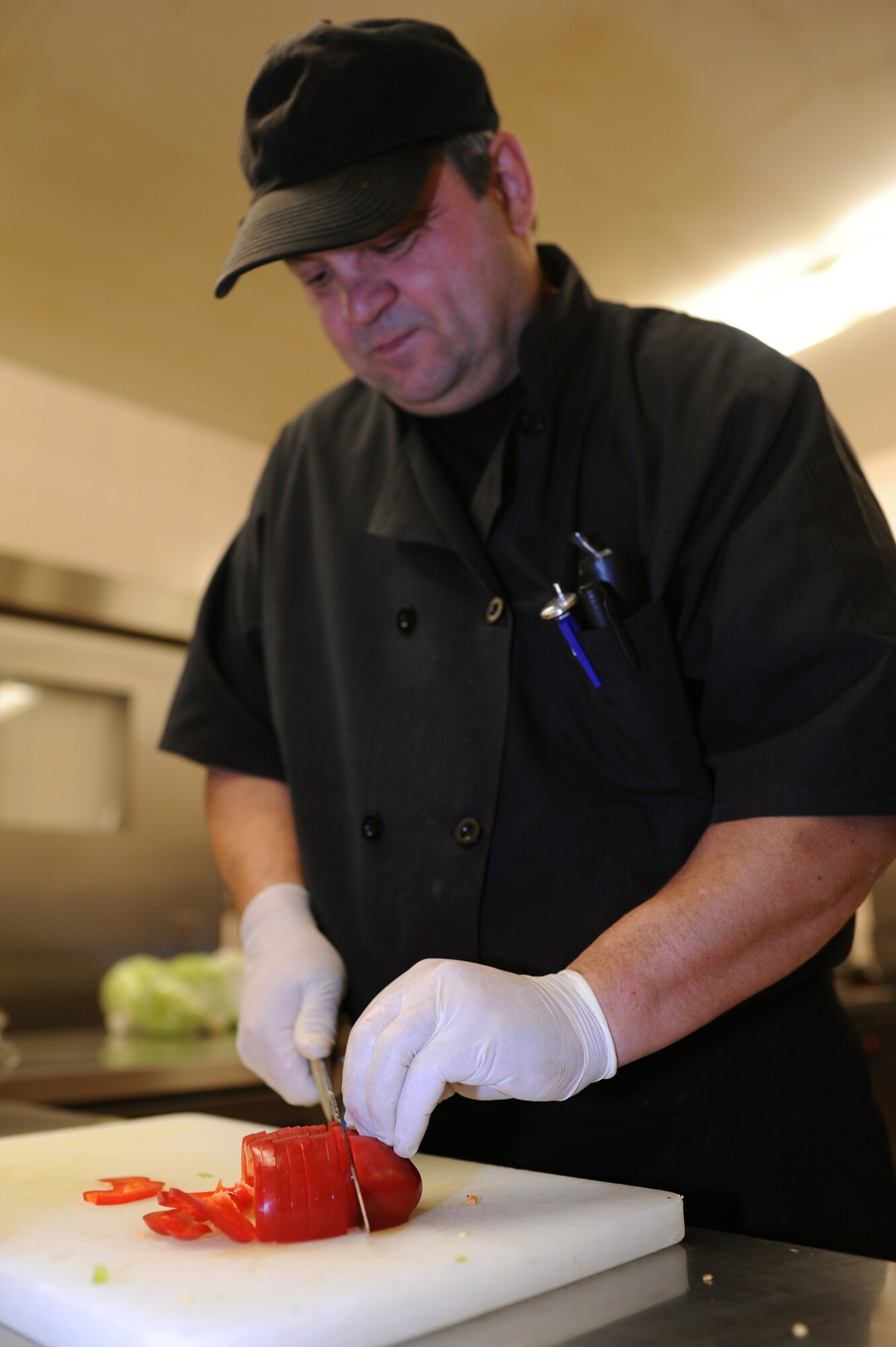 SPANGDAHLEM AIR BASE, Germany – Heinz Toeller, 52nd Force Support Squadron cook, dices a pepper for lunch at Club Eifel here Dec. 1. Club Eifel Catering offers buffets and hors d’oeuvres style meals for pick-up or delivery and a catering staff upon request. For more information, call DSN 452-4642 or 06565-61-4642. (U.S. Air Force photo/Airman 1st Class Matthew B. Fredericks)