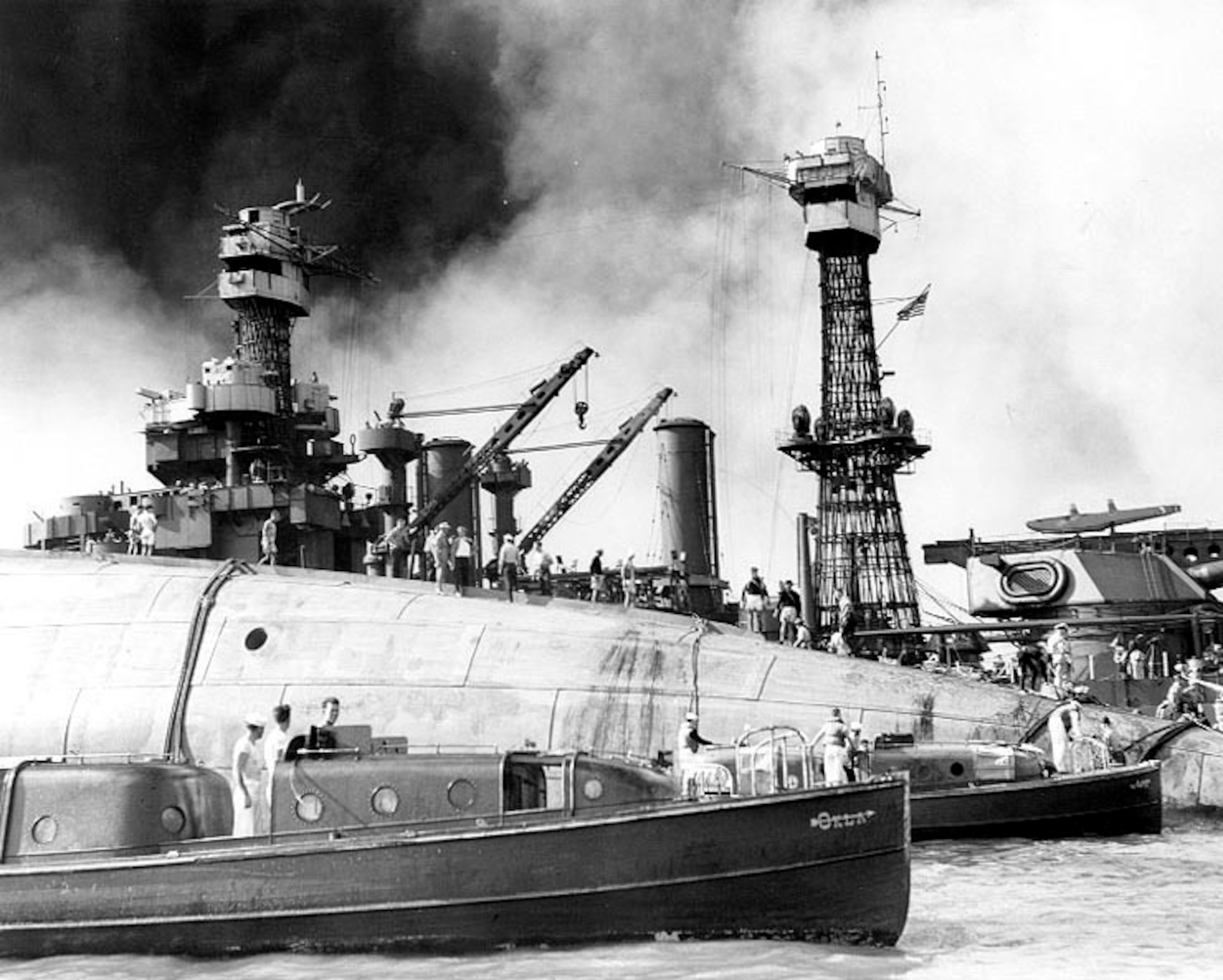 Rescue crews wok on the upturned hull of the 29,000 ton battleship USS Oklahoma (BB 37) Dec. 8, 1941. The ship capsized after being blasted by Japanese warplanes Dec. 7, 1941. Holes were burned through the hull to permit the rescue of some of the men trapped below. (Photo courtesy of Library of Congress archives)
