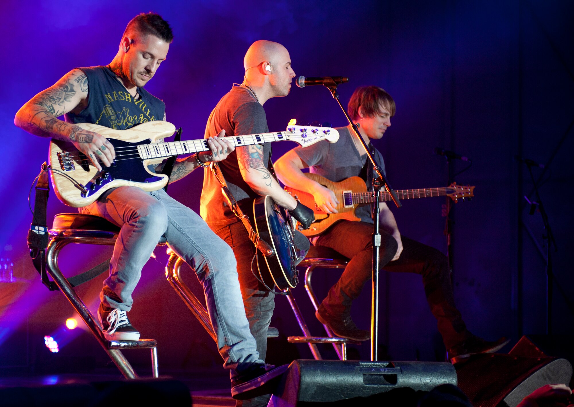 From left to right, bassist Josh Paul, lead singer Chris Daughtry and guitarist Brian Craddock of the band Daughtry play for Airmen and their families during an Operation Seasons Greetings Tour for Troops Dec. 6, 2011, at Incirlik Air Base, Turkey. The OSG is a 13-day, six-concert tour through Southwest Asia and Europe. (U.S. Air Force photo by Senior Airman Anthony Sanchelli/Released)
