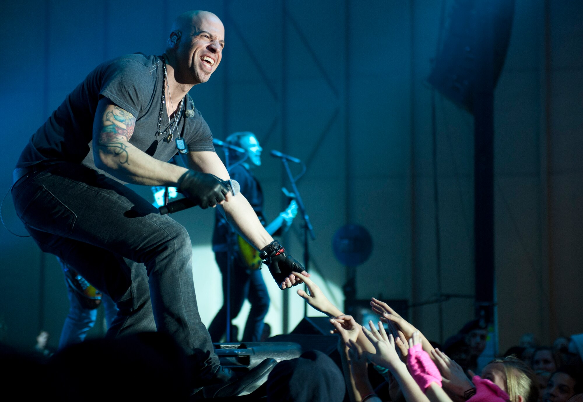 Chris Daughtry, lead singer for the band Daughtry, reaches out to fans during an Operation Seasons Greetings Tour for Troops Dec. 6, 2011, at Incirlik Air Base, Turkey. The OSG is a 13-day, six-concert tour through Southwest Asia and Europe. (U.S. Air Force photo by Senior Airman Anthony Sanchelli/Released)
