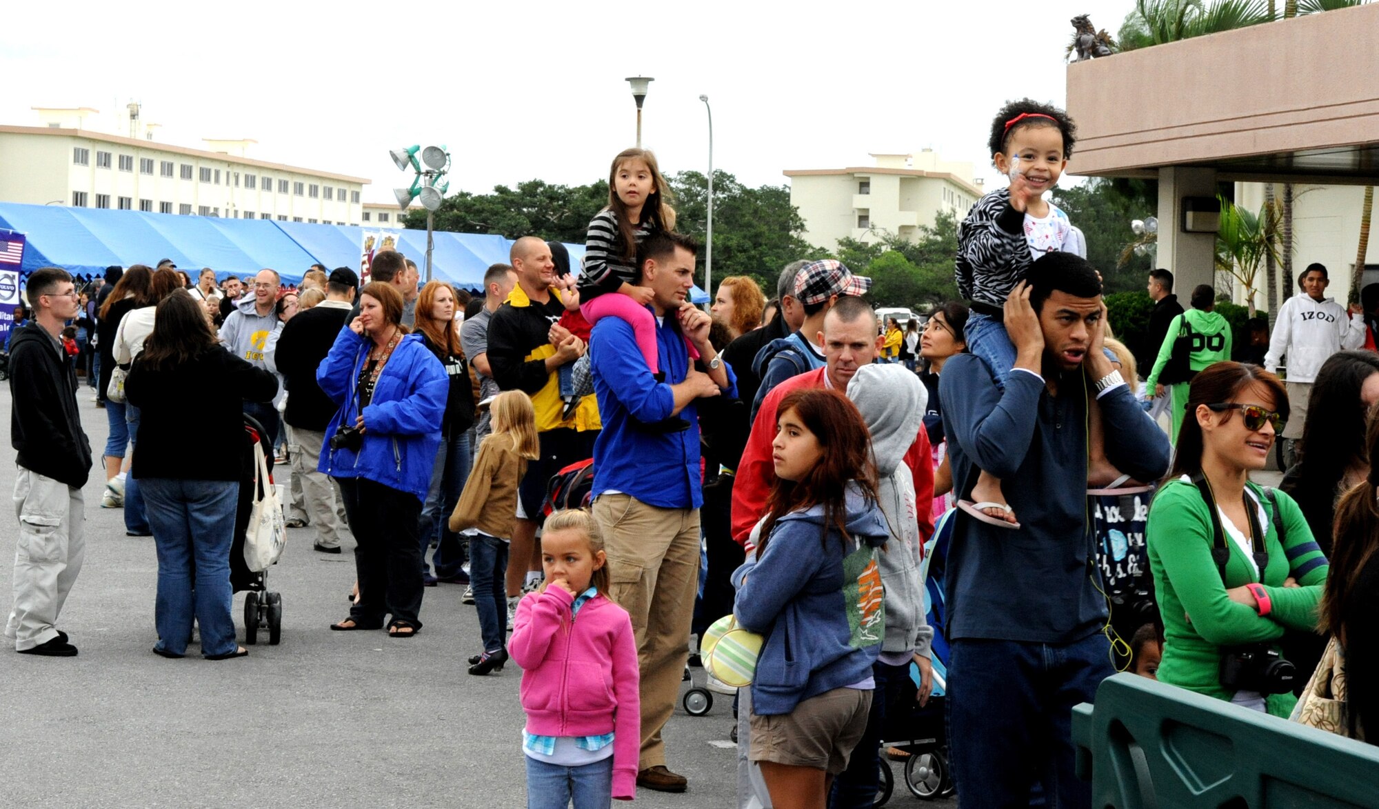Parents and children wait in line for the chance to take pictures with Santa Clause at the Schilling Community Center during the 2011 Tinsel Town on Kadena Air Base, Japan, Dec. 2, 2011. Tinsel Town included many attractions for children including bouncers, a merry-go-round, train rides, and a chance for kids to meet Santa Claus. (U.S. Air Force photo by Airman 1st Class Justin Veazie/Released)
