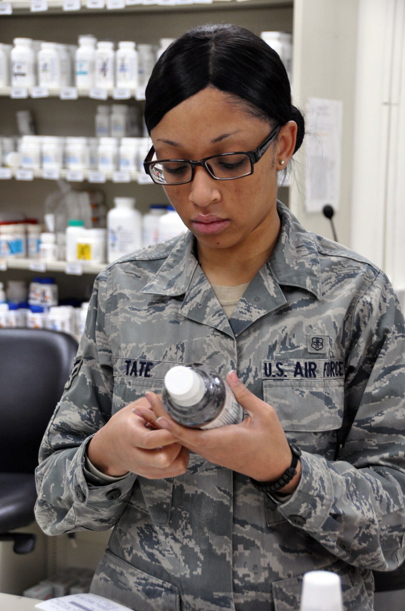 Airman 1st Class Shuntrice Tate, 51st Medical Group pharmacy technician, processes morning prescription refills for patients Dec. 7, 2011. The pharmacy processes nearly 30 refills everyday. (U.S. Air Force photo/ Airman 1st Class Michael Battles)