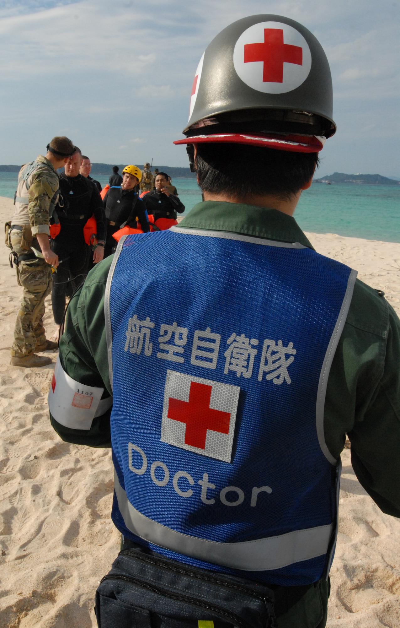 U.S. Air Force members of the 31st Rescue Squadron and  the Japanese Air Self Defense Force  work to secure and treat simulated patients during the Cope Angel exercise in Okinawa, Japan, Dec. 5, 2011.Cope Angel exercise is used to increase combat readiness, highlight interoperability amongst the Japanese and U.S forces and to demonstrate effective planning and execution. (U.S. Air Force photo by Tech. Sgt. Lakisha A. Croley/Released) 