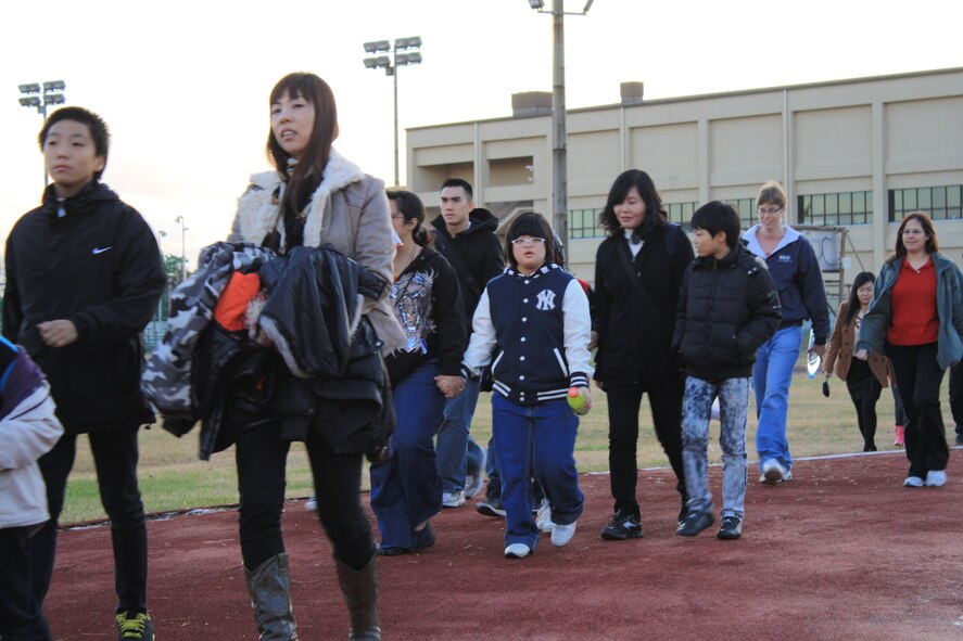 After an hour of game time at the base’s fitness center, Ilmagwon Orphanage children and their sponsors travel to the base chapel’s SonLight Inn for dinner during their visit for a Christmas party at Kunsan Air Base, Republic of Korea, Dec. 3, 2011. With open arms, 63 Wolf Pack members graciously welcomed the orphans to their home for an afternoon of fun, games, food and presents. (U.S. Air Force photo by Staff Sgt. Robert Webb/Released)