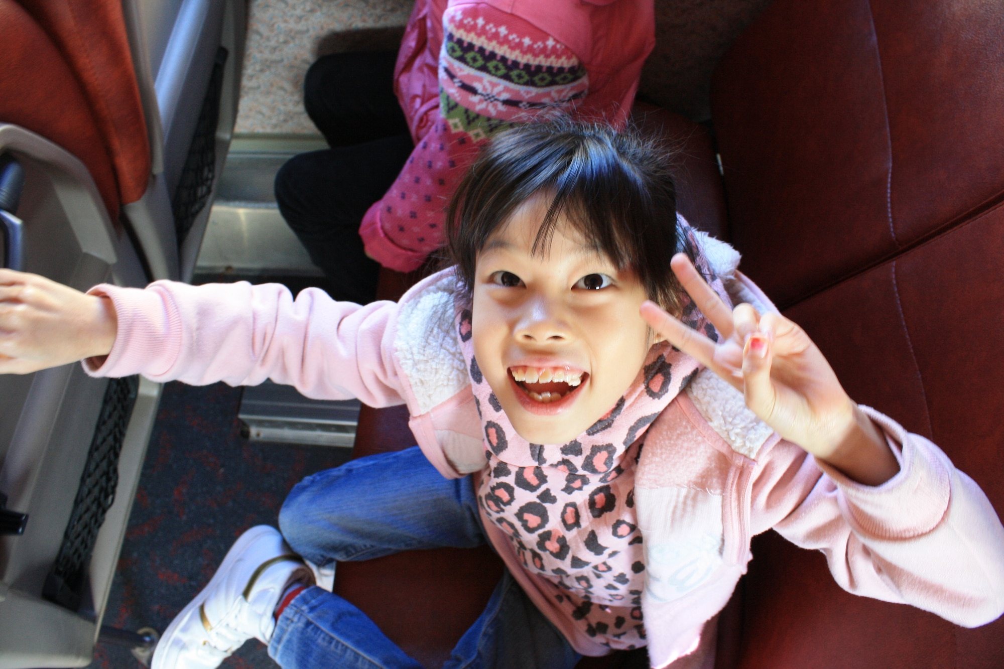 An Ilmagwon Orphanage girl throws up the peace sign as she poses for a photo during her visit for a Christmas party at Kunsan Air Base, Republic of Korea, Dec. 3, 2011. With open arms, 63 Wolf Pack members graciously welcomed the orphans to their home for an afternoon of fun, games, food and presents. (U.S. Air Force photo by Staff Sgt. Robert Webb/Released)