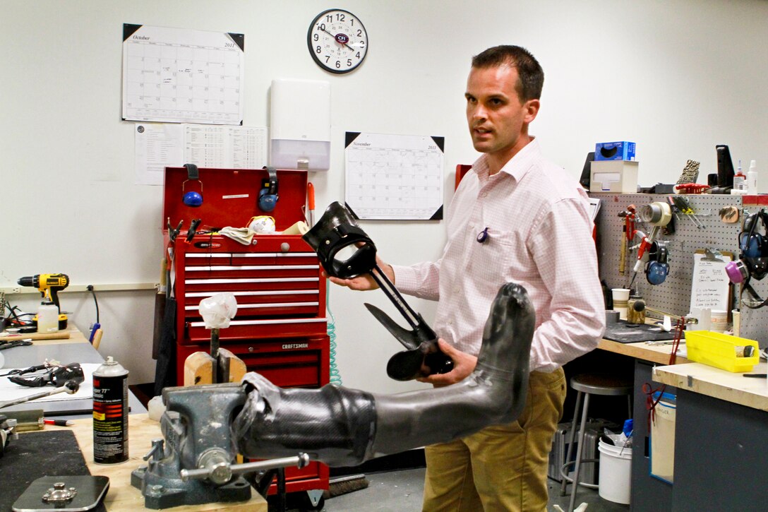 Ryan Blanck, a prosthetist and creator of the Intrepid Dynamic Exoskeletal Orthosis brace, discusses how he makes the device in his lab at the Center for the Intrepid in San Antonio, Nov. 9, 2011. The brace reduces pain for soldiers who suffered leg injuries and increases mobility, including the ability to run.