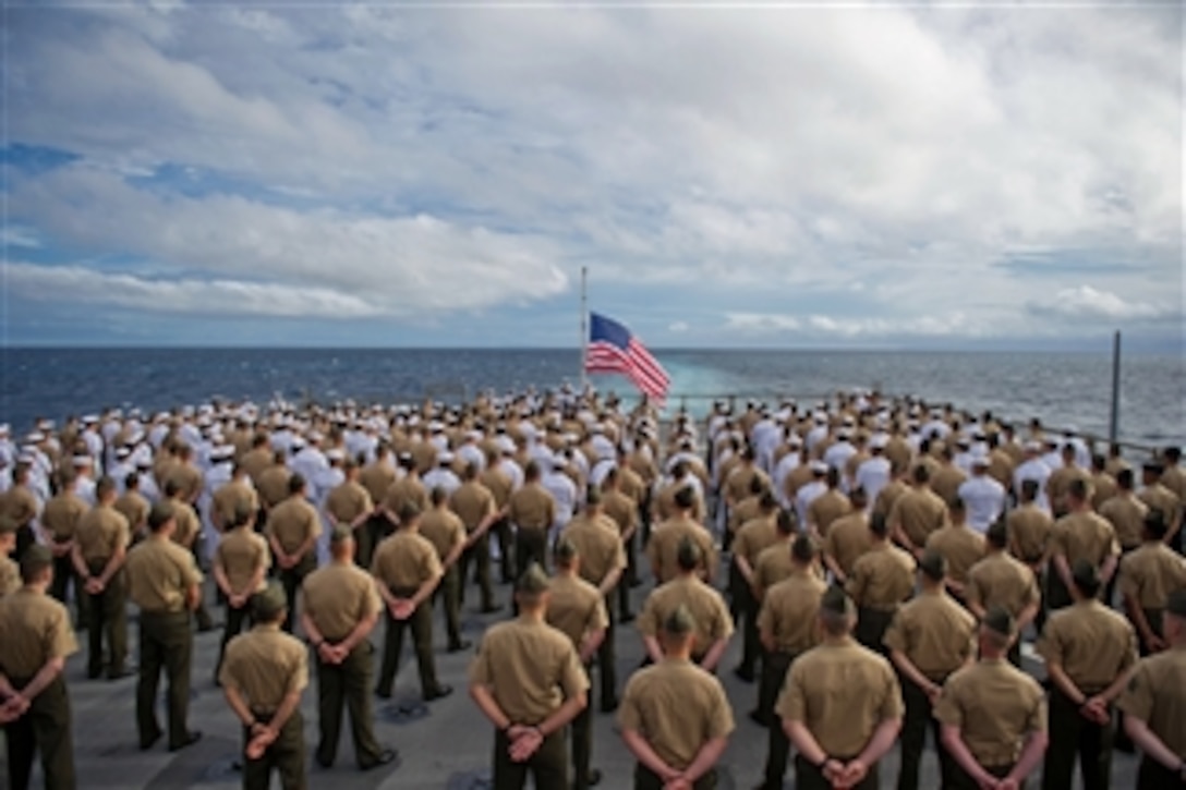 Marines with the 11th Marine Expeditionary Unit and sailors aboard the USS Pearl Harbor (LSD 52) stand in formation during a 70th anniversary commemoration ceremony of the attack on Pearl Harbor on Dec. 7, 2011.  The unit embarked the USS Makin Island, the USS New Orleans and the USS Pearl Harbor in San Diego on Nov. 14 beginning a seven-month deployment to the western Pacific and Middle East regions.  