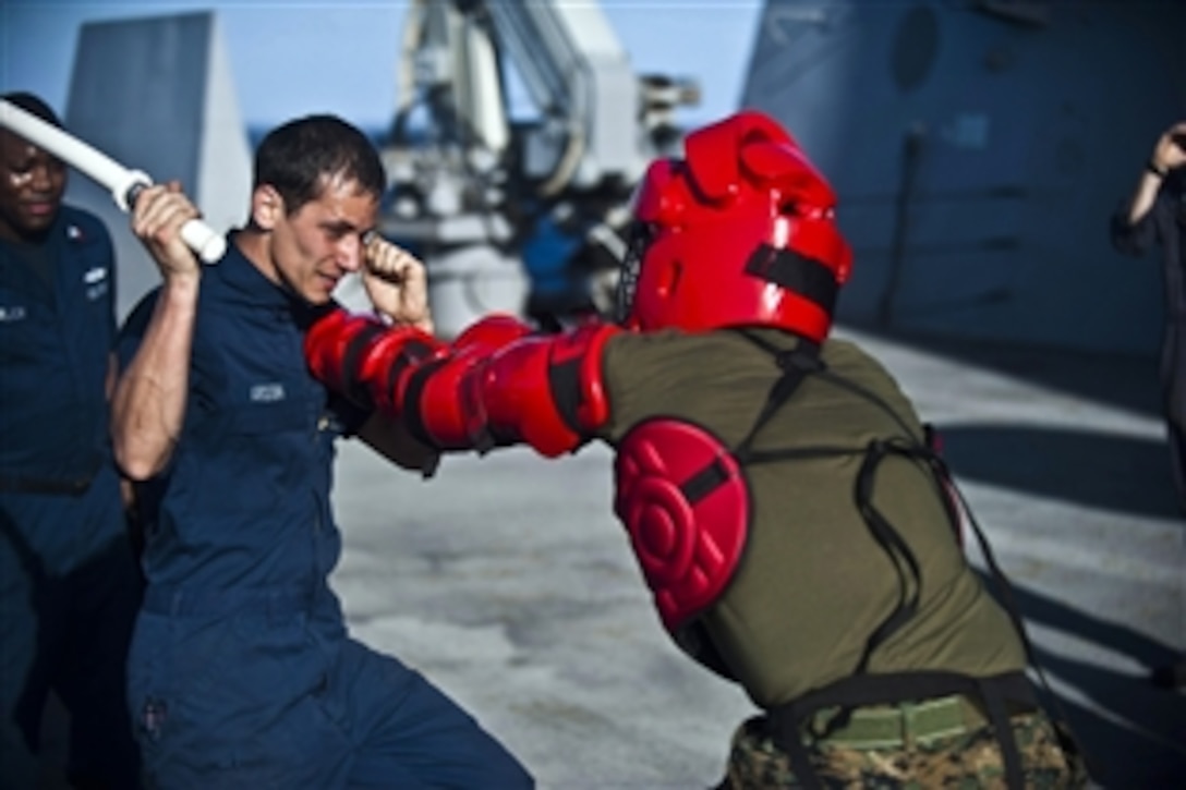 U.S. Navy Seaman Nicholas Ardoin defends against a simulated attacker after being sprayed with Oleoresin Capsicum during qualifications aboard the amphibious transport dock ship USS New Orleans under way in the Pacific Ocean, Dec. 3, 2011. Ardoin is a hull technician fireman. The New Orleans is conducting operations in the U.S. 7th Fleet area of responsibility as part of the Makin Island Amphibious Ready Group. 