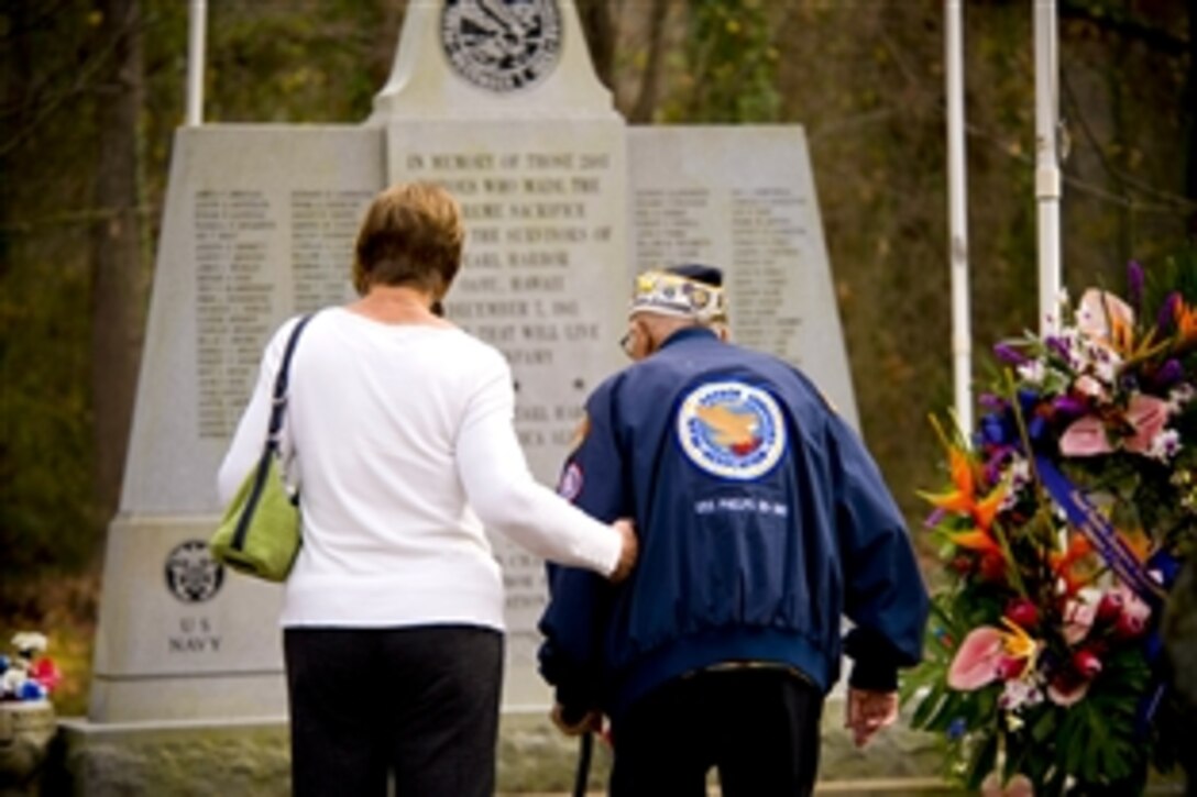 Frank Chebetar, president of the Pearl Harbor Survivors Association, Tidewater Chapter 2, visits a Pearl Harbor memorial with his daughter before the Pearl Harbor Remembrance Ceremony at Joint Expeditionary Base Little Creek-Fort Story in Hampton Roads, Va., Dec. 7, 2011. The event commemorated the 70th anniversary of the attack on the Pearl Harbor, Hawaii. 