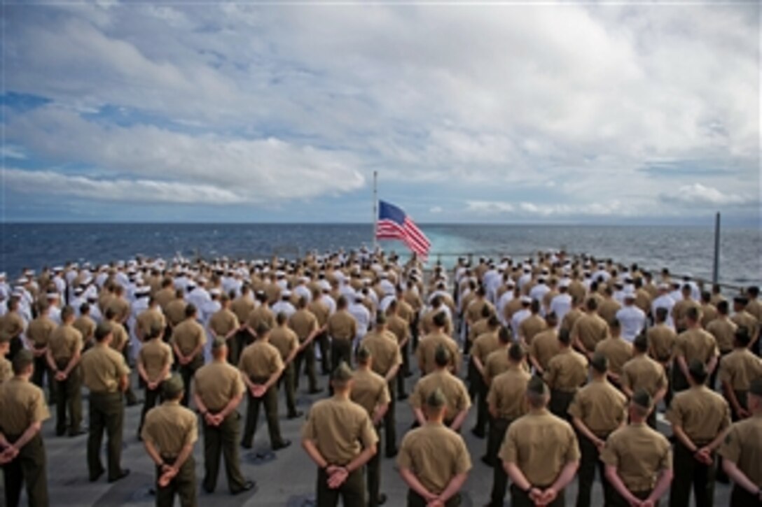 Marines with the 11th Marine Expeditionary Unit and sailors aboard the USS Pearl Harbor (LSD 52) stand in formation during a 70th anniversary commemoration ceremony of the attack on Pearl Harbor on Dec. 7, 2011.  The unit embarked the USS Makin Island, the USS New Orleans and the USS Pearl Harbor in San Diego on Nov. 14 beginning a seven-month deployment to the western Pacific and Middle East regions.  