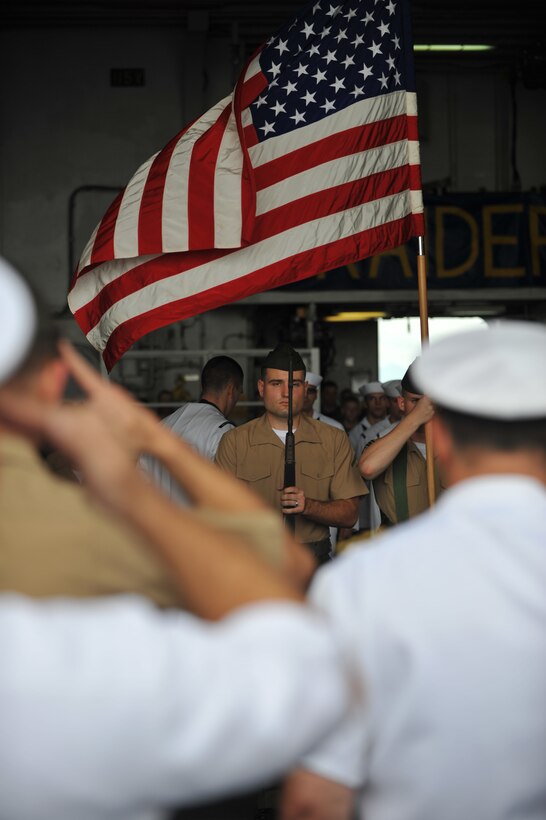 Lance Cpl. Brandon Andrews presents his rifle during a ceremony commemorating the 70th anniversary of the attack on Pearl Harbor aboard USS Makin Island here Dec. 7. Andrews serves with the 11th Marine Expeditionary Unit's command element. The unit embarked USS Makin Island, USS New Orleans and USS Pearl Harbor in San Diego Nov. 14 to begin a seven-month deployment to the Western Pacific and Middle East regions.