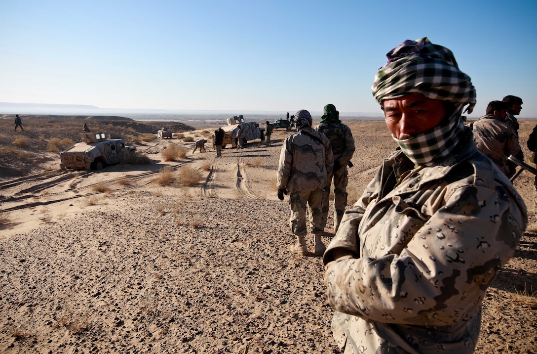 A policeman with 1st Kandak, 6th Zone, Afghan Border Police, stands watch during a movement toward the Afghanistan border. The movement signaled the start of Operation Eagle Hunt, an effort led by Afghan National Security Forces to seek out insurgents in the area.  Roughly 100 ANSF members executed the mission and led their U.S. Marine counterparts in the shaping operation, preparing the area for future counterinsurgency operations.