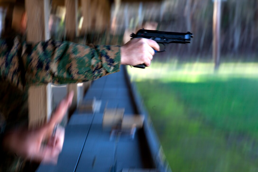 1st Tanks quarterback Brett Bergeron throws the ball as the Rhinos’ Alex Esparza pass rushes the Quarterback during the Commanding General’s Intramural Flag-Football championship game at Felix Field Dec. 8, 2011.
