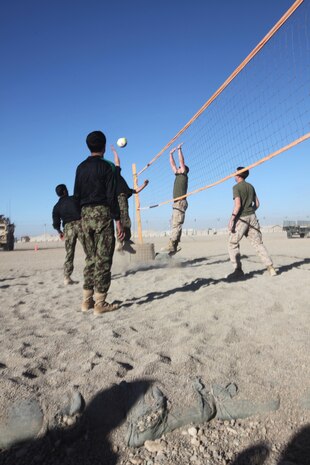 Marines with the Embedded Partnering Team, 2nd Marine Logistics Group (Forward), play a final farewell game of volleyball with their Afghan counterparts aboard Camp Leatherneck, Afghanistan, Dec. 9.  The Marines and ANA soldiers have been training and working together for the past several months in various logistics operations.  (U.S. Marine Corps photo by Cpl. Katherine M. Solano)