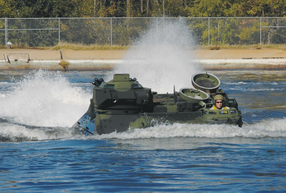An amphibious assault vehicle proves its seaworthiness during testing at Maintenance Center Albany’s Test Pool, recentlys. Robert ‘Cujo’ Terry, heavy mobile equipment supervisor, Cost Work Center 723B, Maintenance Center Albany, demonstrates its ability to conduct amphibious operations by taking the AAV for a ‘swim.’