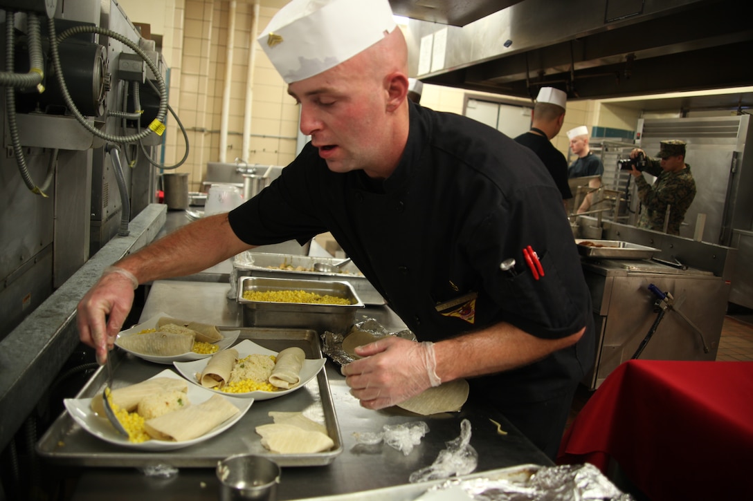 Cpl. Robert Hartnett, a food service specialist with Marine Wing Support Squadron 271 puts the finishing touches on his fajita and rice entrée preparing for the MCAS Cherry Point Chef of the Quarter Competition at the Cherry Point mess hall Dec. 8. The winner of the Chef of the Quarter will compete against the previous two winners for a chance to study at the Culinary Institute of America in Hyde Park, N.Y.